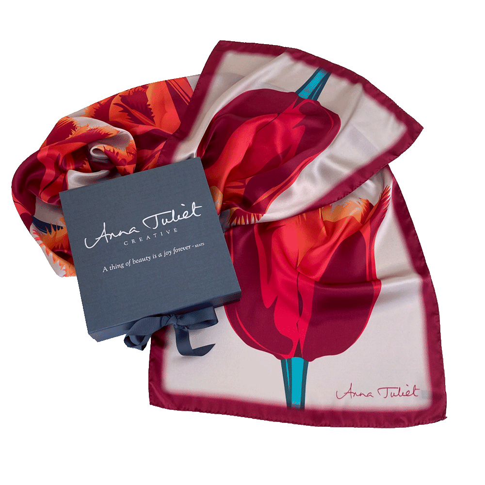 Floral pure silk scarf draped around a branded pewter-coloured gift box. Orange and Pink Tulip on Beige by Anna Juliet Creative. Limited edition silk scarf made in the UK.