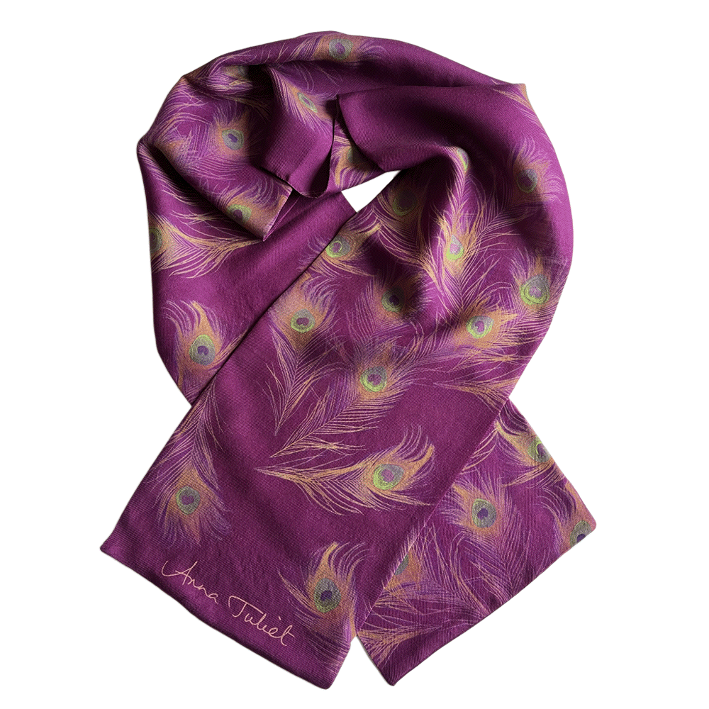 Fine wool silk mix luxury scarf for the Autumn/Winter season. The delicate peacock feather design in golds and greens complements the deep mulberry tone of the scarf.