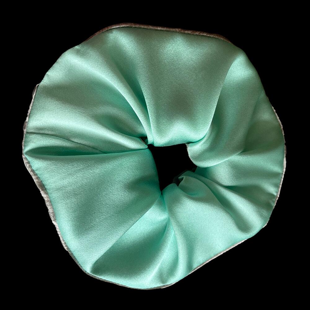 Aquamarine blue coloured large scrunchie (7cm deep) with a signature silver-grey patterned silk satin print on the reverse. Part of a luxury gift set made from 95% silk satin and 5% elastane.