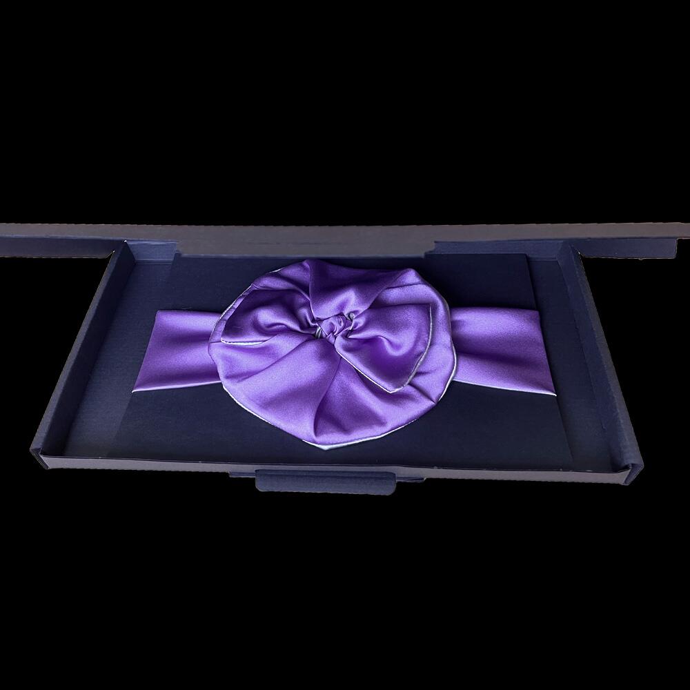 Mauve silk scrunchie and headband displayed in a black gift box.