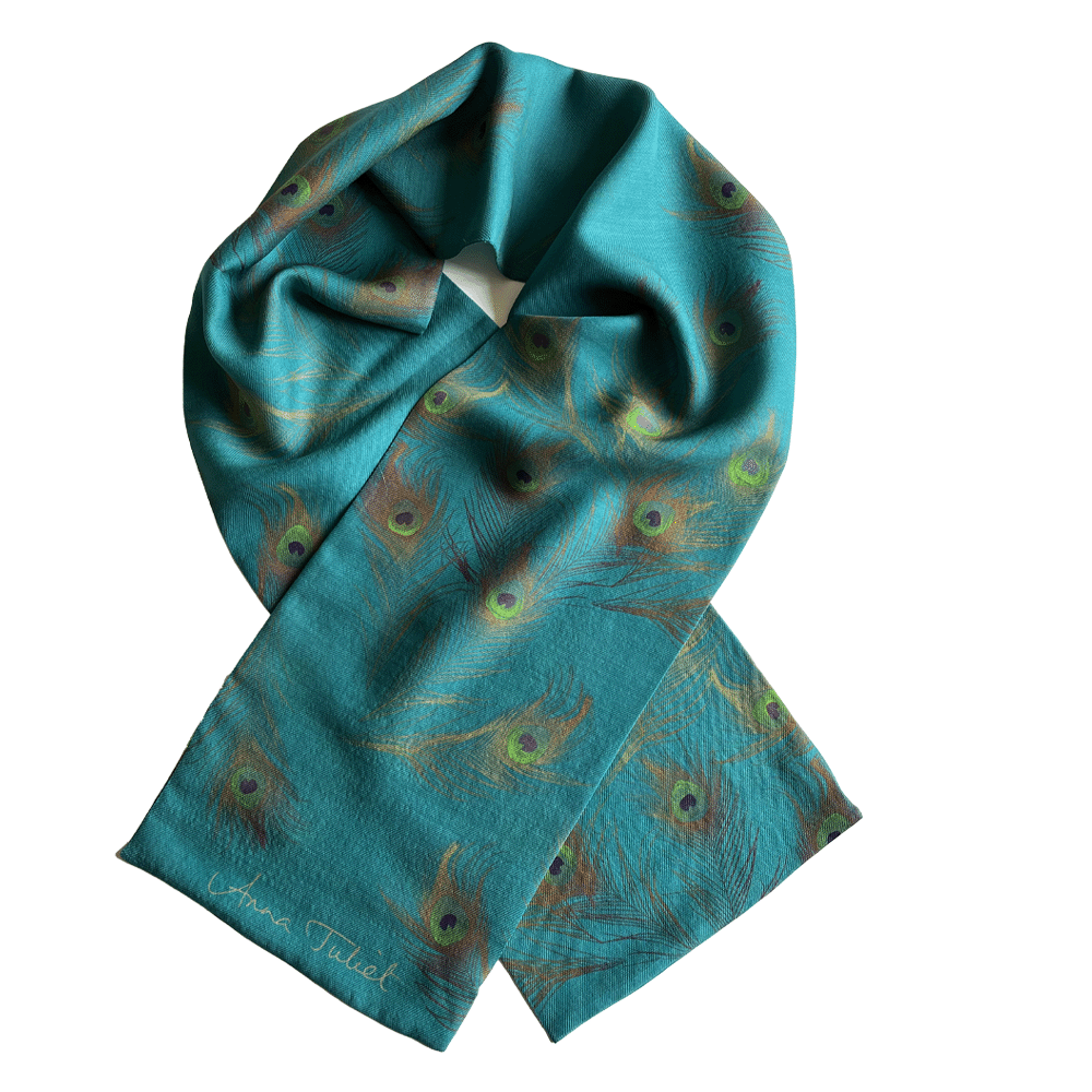 A fine wool and silk neck scarf with a peacock feather design on a teal background.
