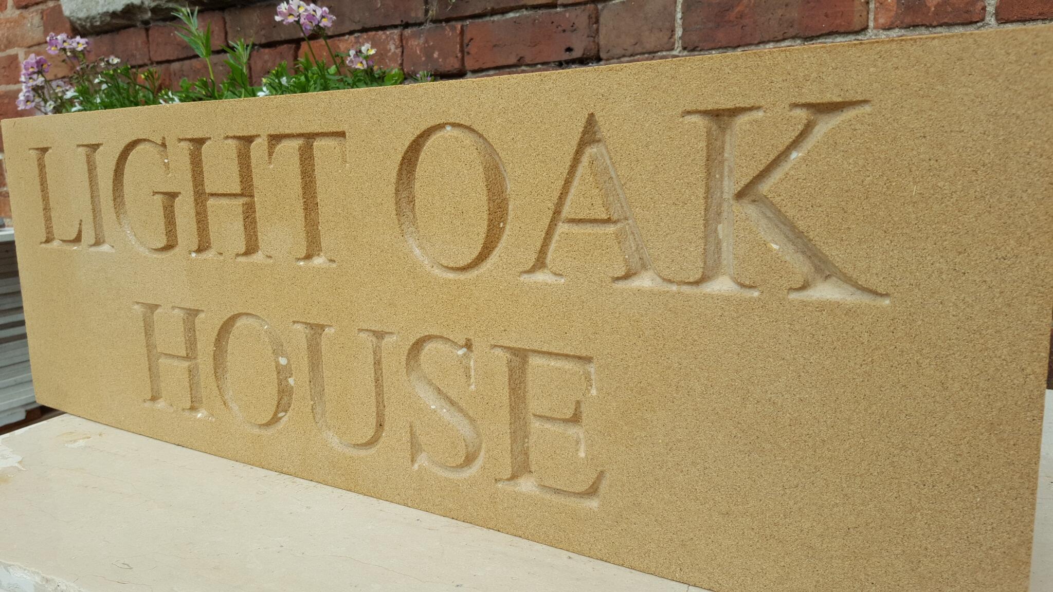 Deeply engraved stone house signs and dates stones in different sizes