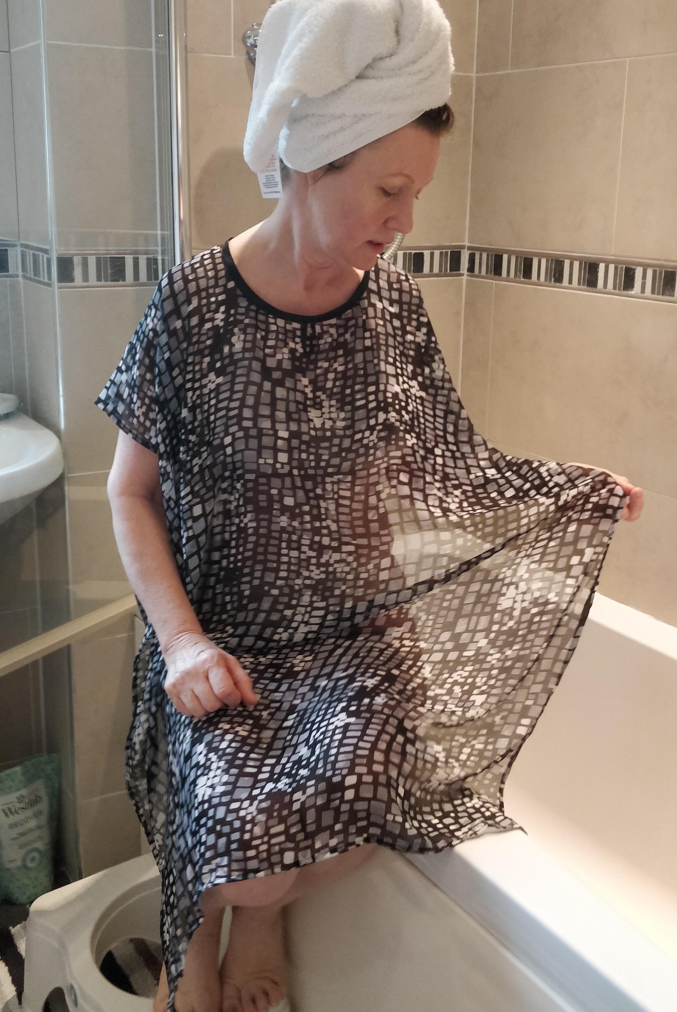 Black Abstract NeverNaked(tm) Shower Drapron® to provide modesty, dignity and privacy whilst being helped to shower or bathe. Shower modesty wear. Bathing modesty gown. Lightweight crepe chiffon. Slips over shoulders - No sleeves. Magnetic fastening at back