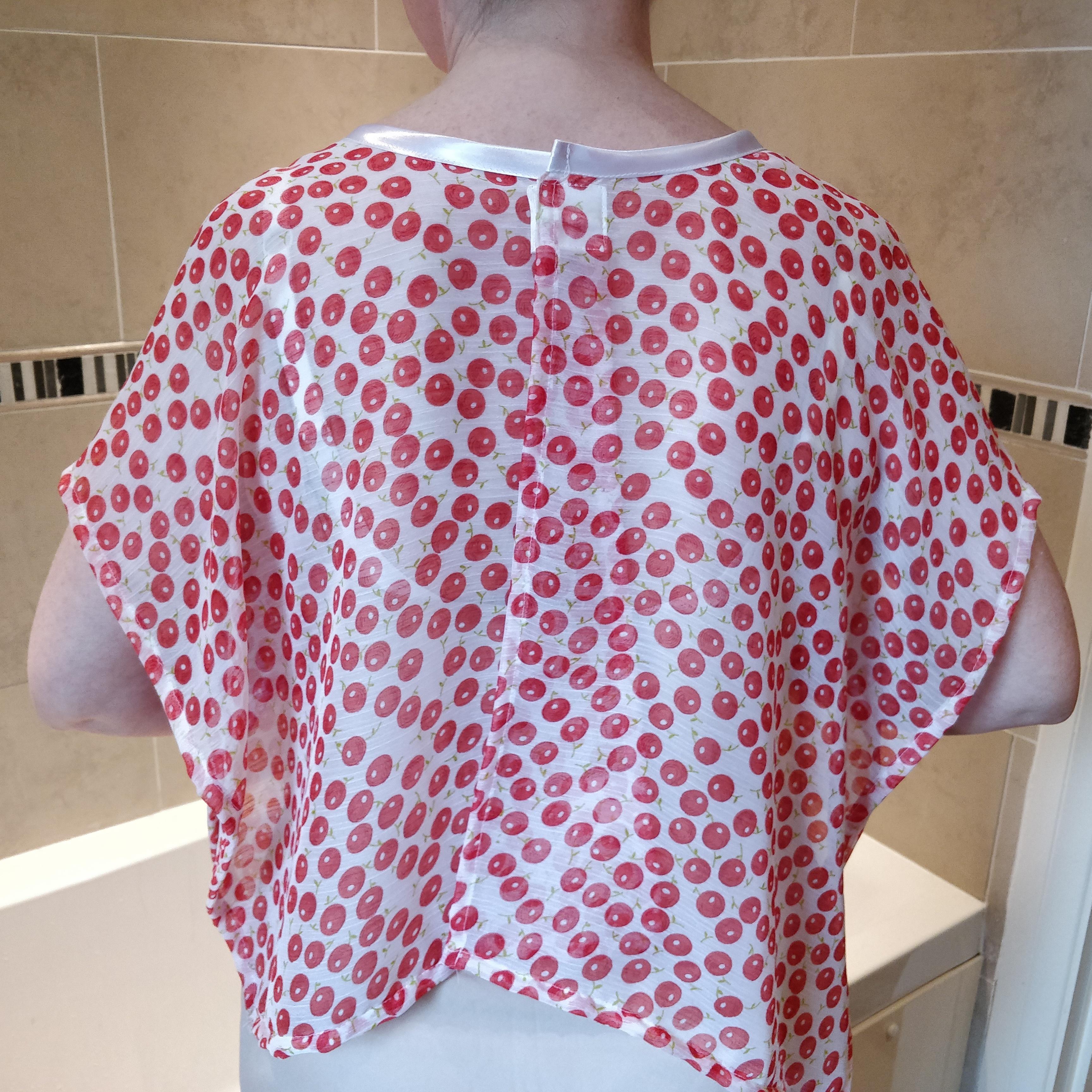 Soft Red NeverNaked(tm) Shower Drapron® showing the back view - Drapronr comes down to approximatley waist level and fastens at the back with a magnetic fastening