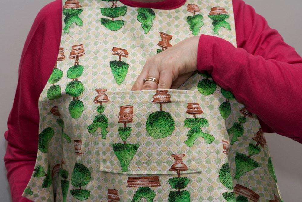 Showing pocket on topiary design dining drApron / clothing protector. So much more dignified and attractive than an adult bib. Looks equally good on men and women