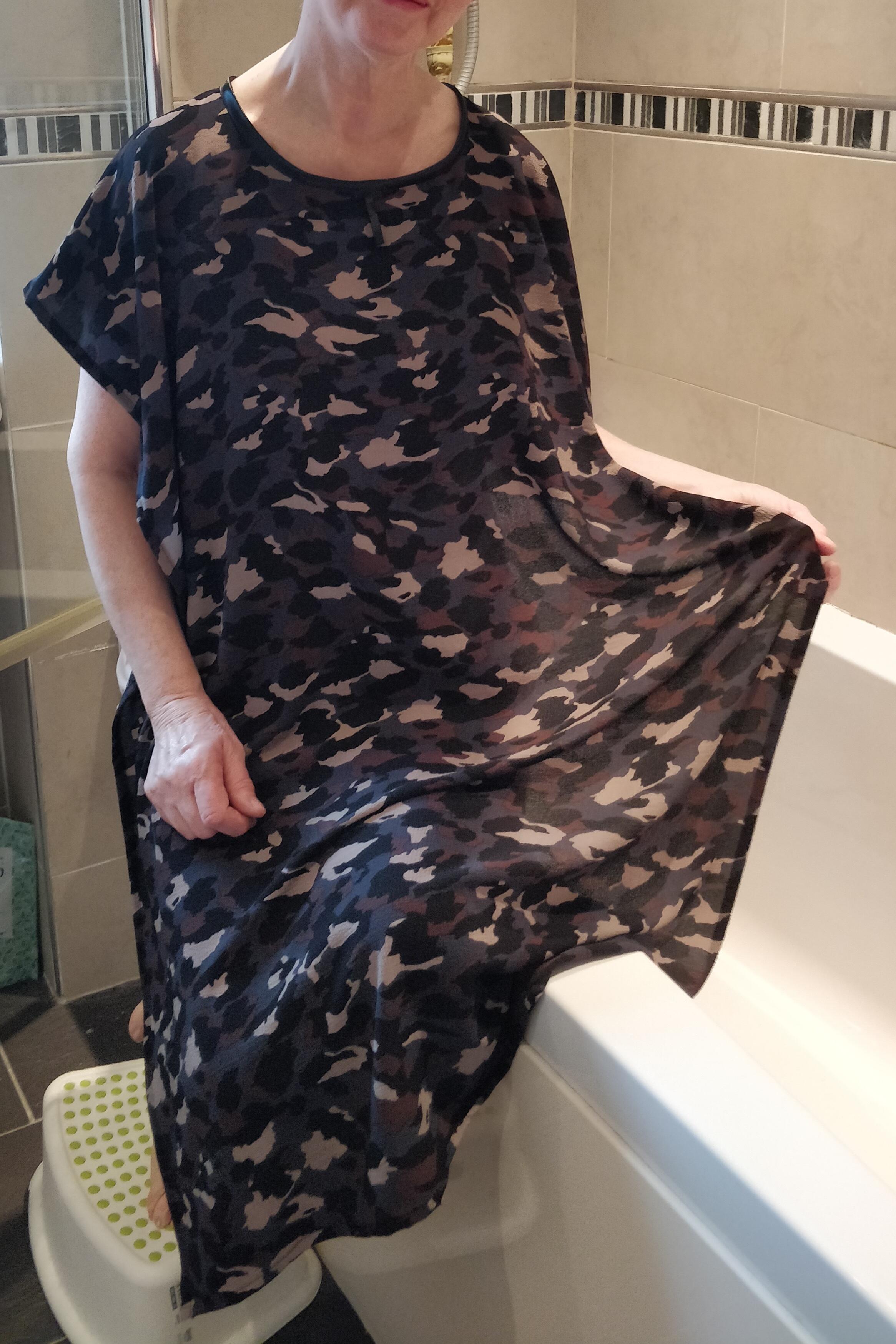 Dark Camouflage design NeverNaked(tm) Shower Drapron® to provide modesty, dignity and privacy whilst being helped to shower or bathe. Shower modesty wear. Bathing modesty gown. Lightweight crepe. Slips over shoulders - No sleeves Magnetic fastening at back