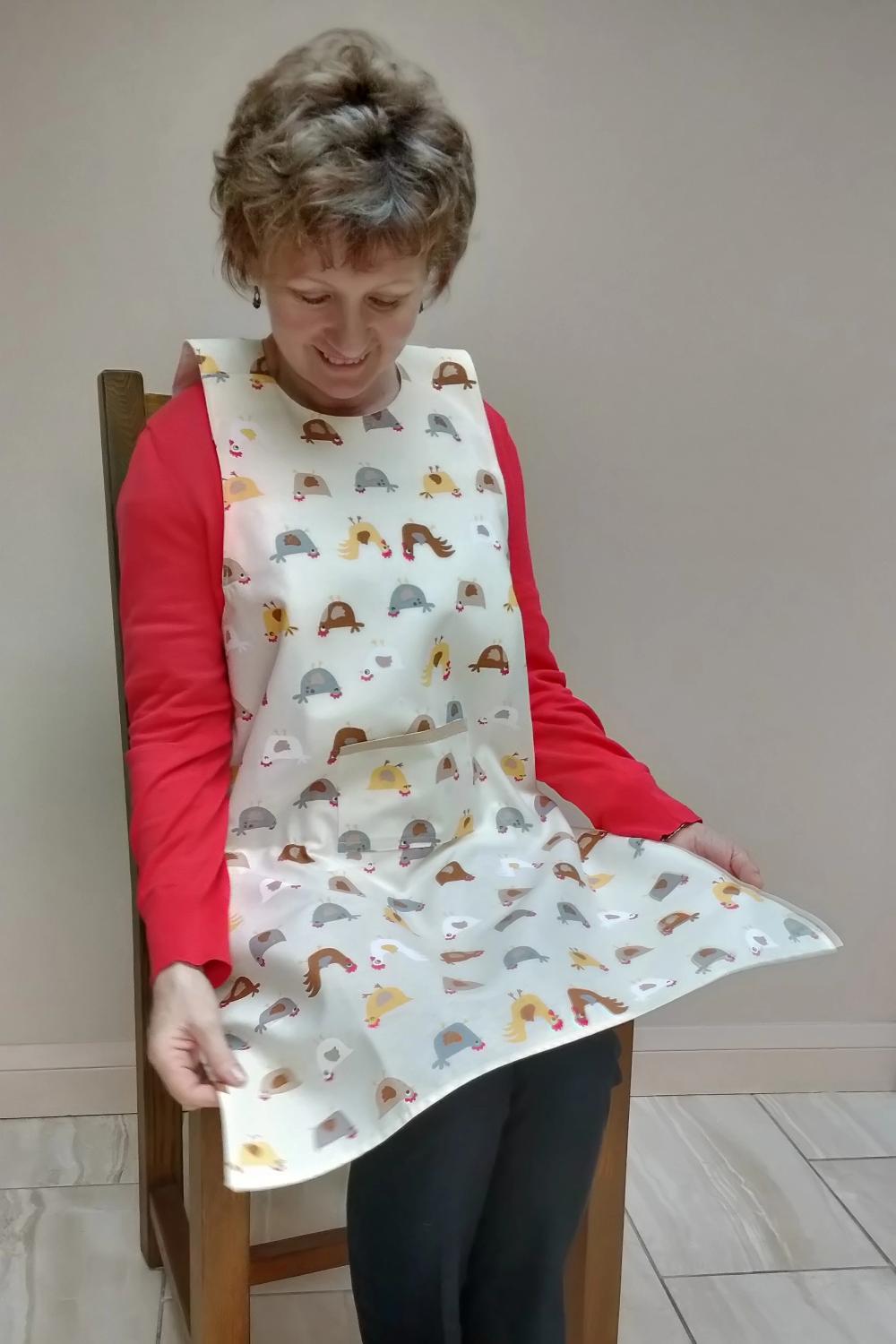 Dining drApron® in chickens pattern Cream background wiht chickens & roosters in yellow, brown, grey & red. Clothing protector that looks like an apron so no stigma of an adult bib