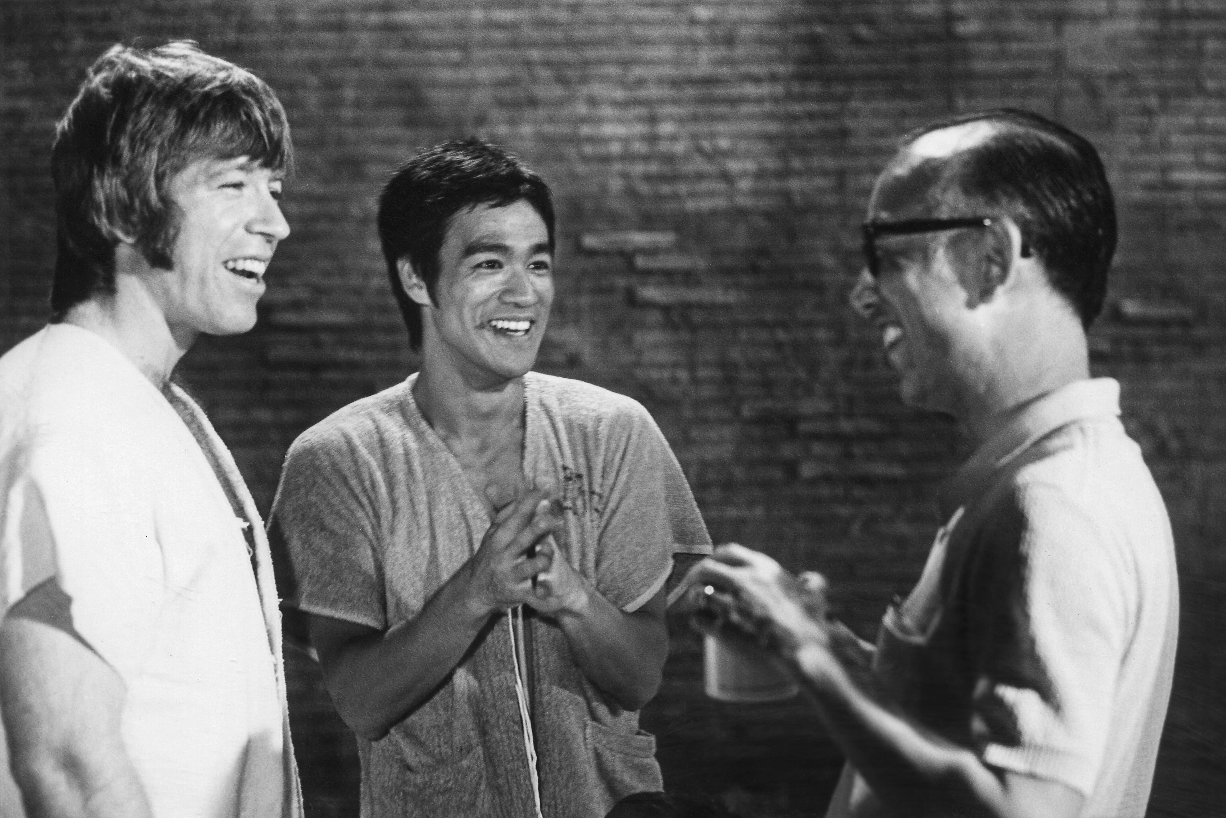 Chuck Norris, Bruce Lee, and Hong Kong producer Raymond Chow sharing a light-hearted moment between takes while filming their now iconic “gladiator” duel in Rome’s Colosseum for the 1972 martial arts classic The Way of the Dragon (Return of the Dragon).