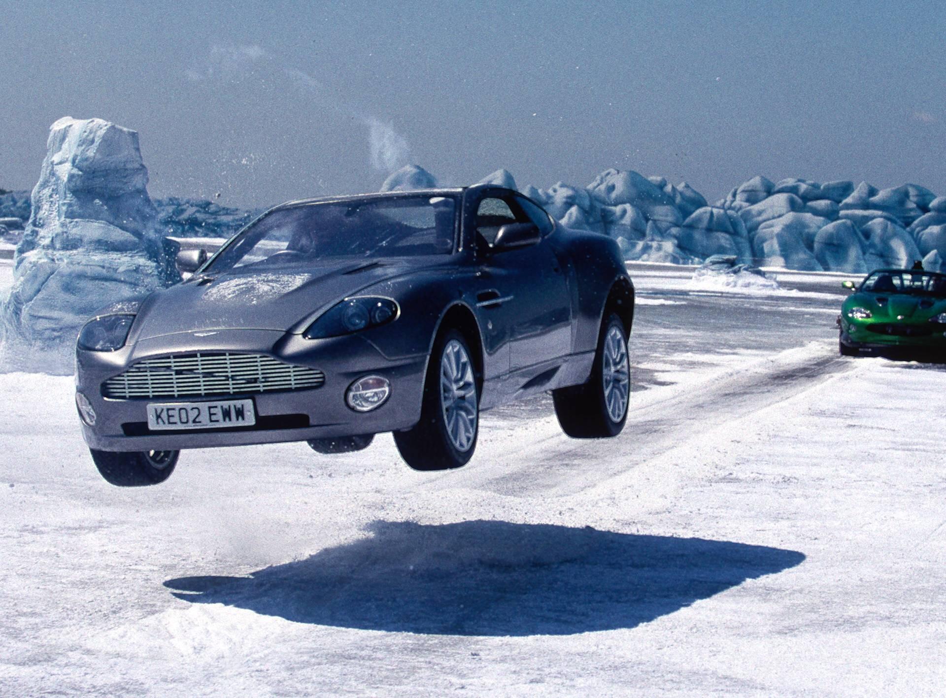 A cinematic action shot of James Bond’s Aston Martin V12 Vanquish jumping through the air during the ice chase sequence in Die Another Day (2002).