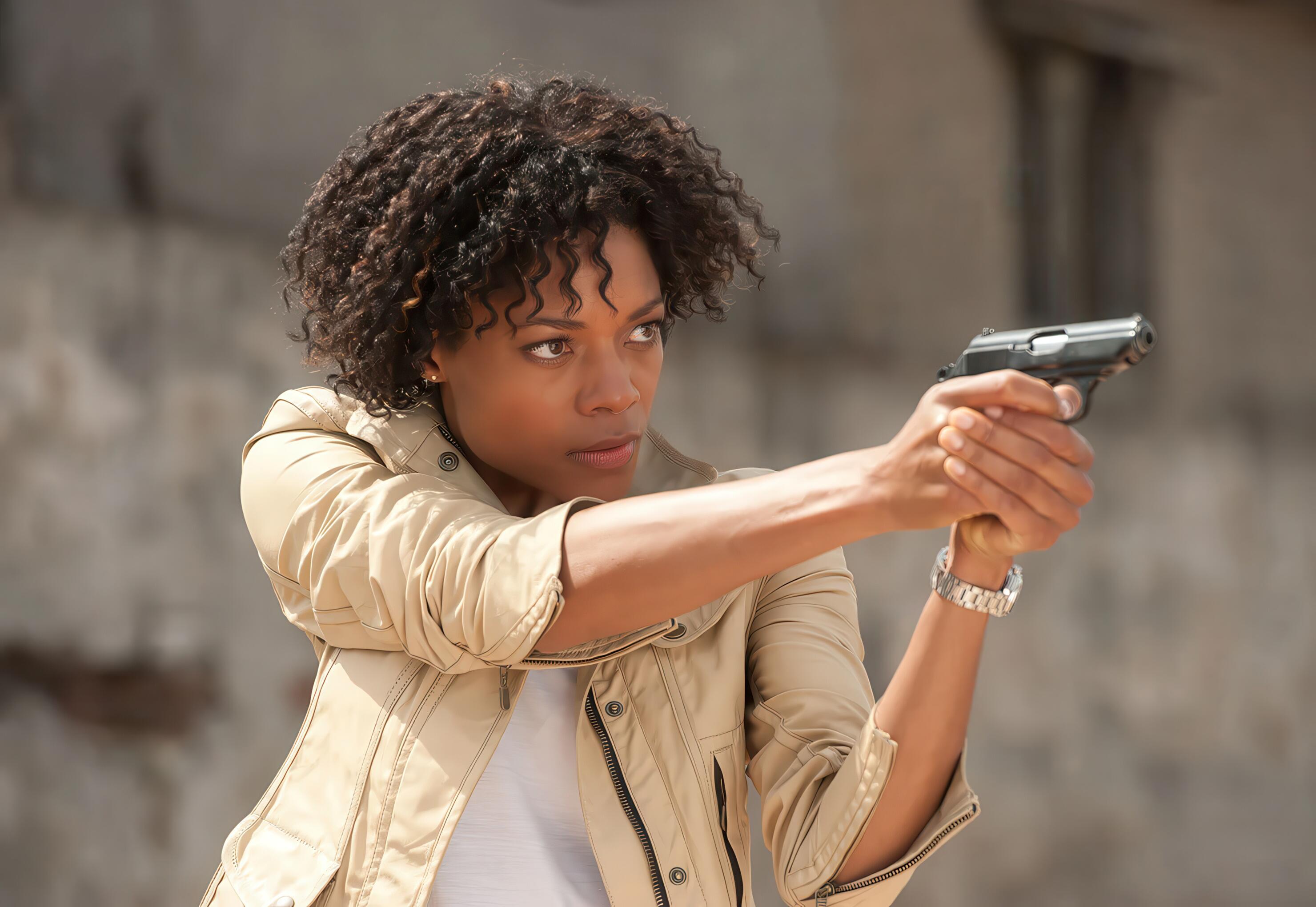 Naomie Harris as Moneypenny, firearm drawn and ready for action, in the thrilling opening action sequence for Skyfall (2012)