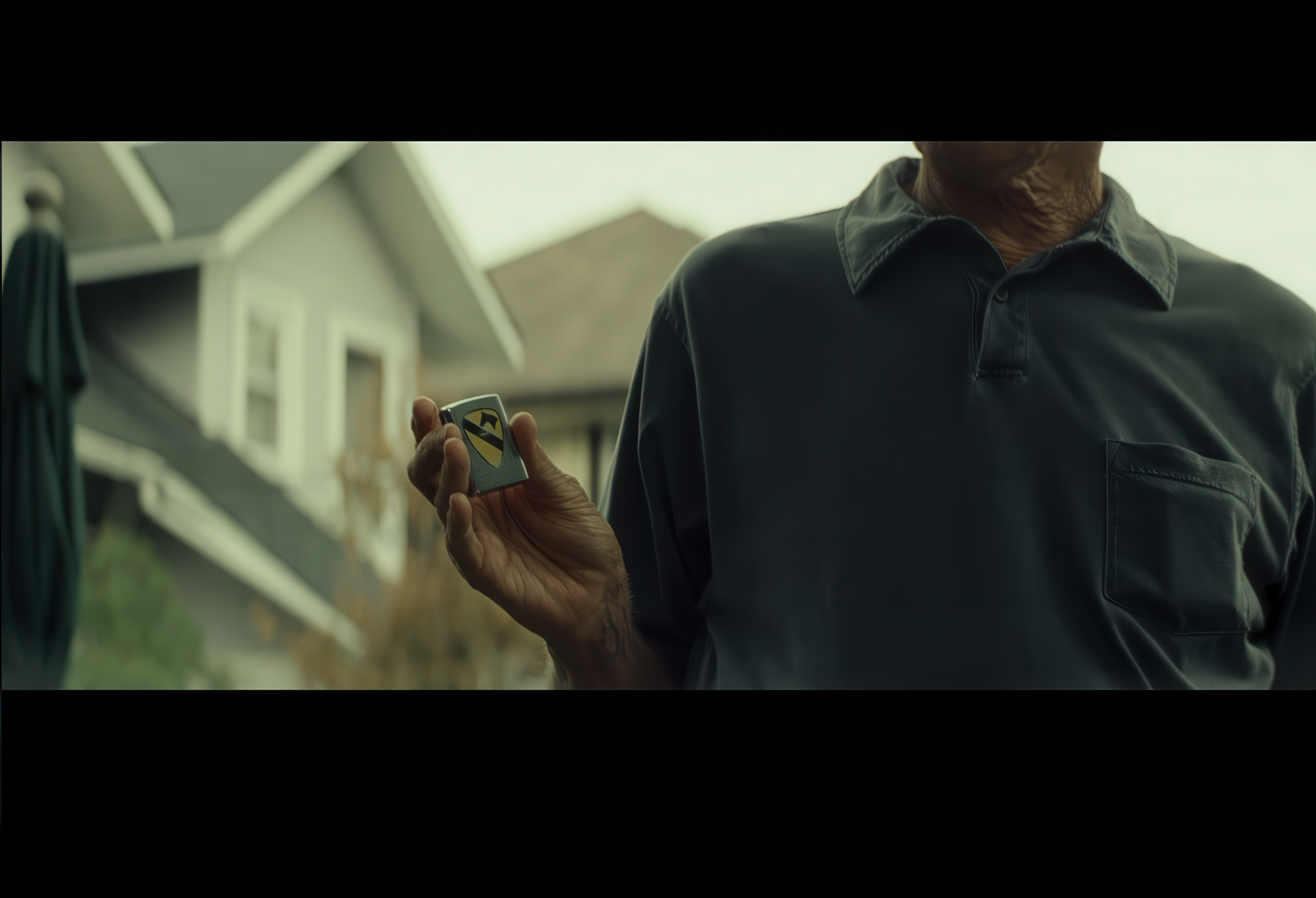 Walt Kowalski holding the zippo lighter from a scene in Gran Torino