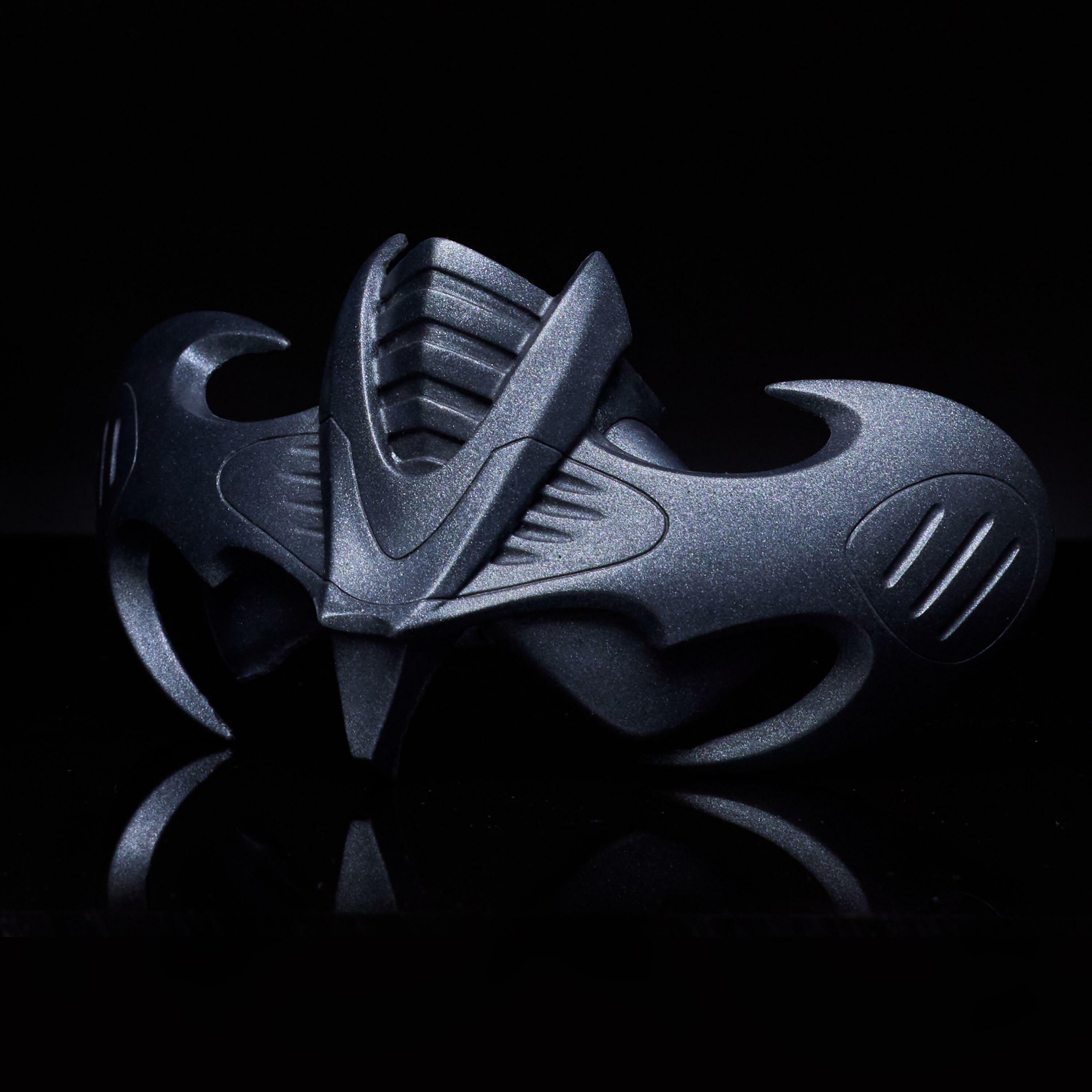 Bat-shaped rebreather prop used by Batman in Batman Forever, shown against a dark reflective surface.
