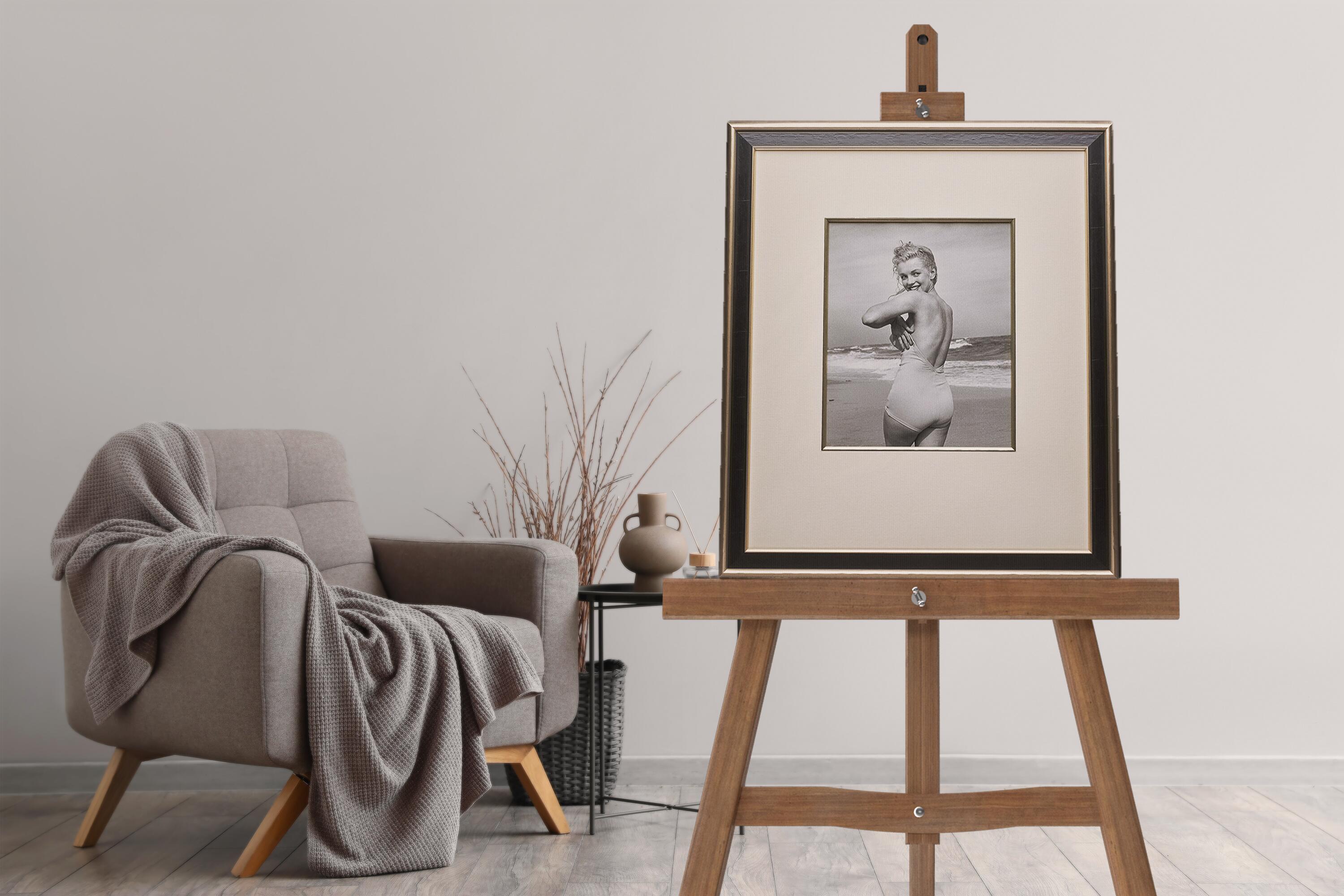 Marilyn Monroe ‘Playful in a Swimsuit’ – Iconic Photograph by André de Dienes on an easel