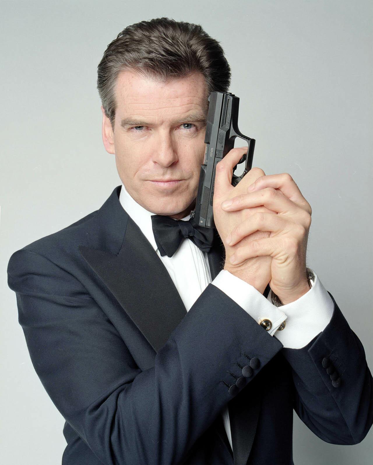 Pierce Brosnan as James Bond, 007, posing with a Walther P99