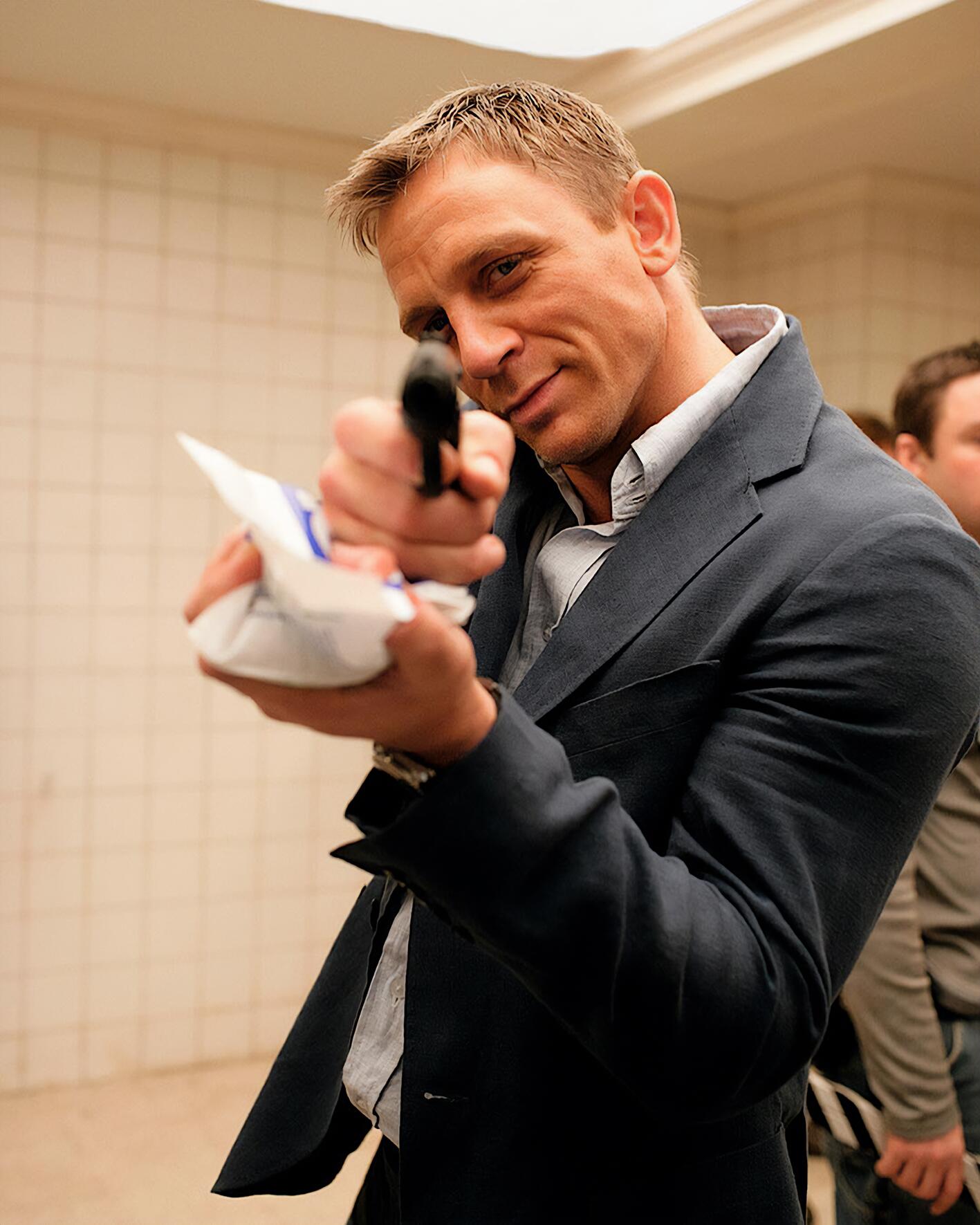 A humorous behind the scenes take on the quintessential "hero shot" of Daniel Craig’s James Bond, capturing the blend of grit and classic 007 sophistication that defined his era.