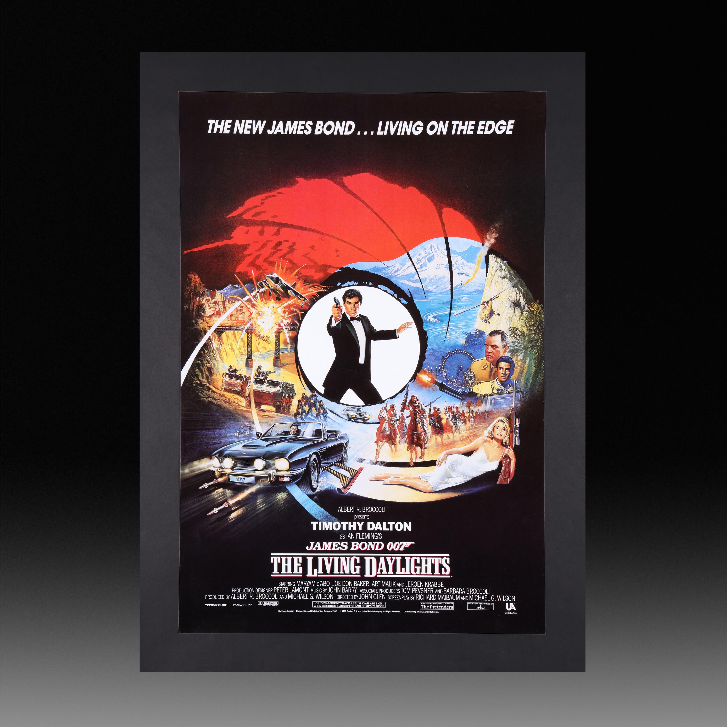 The Living Daylights (1987) Original British One Sheet Poster available for sale at Kudos Memorabilia Ltd. It features Dalton - as Bond with his famous Walther PPK - standing in the middle of the iconic gun barrel graphic, surrounded by a rich collage of action, explosions, villains and a beautiful girl (Maryam D'Abo). The poster also includes the famous Aston Martin V8 Vantage Volante Series II 'Q'ed up' in all its glory!