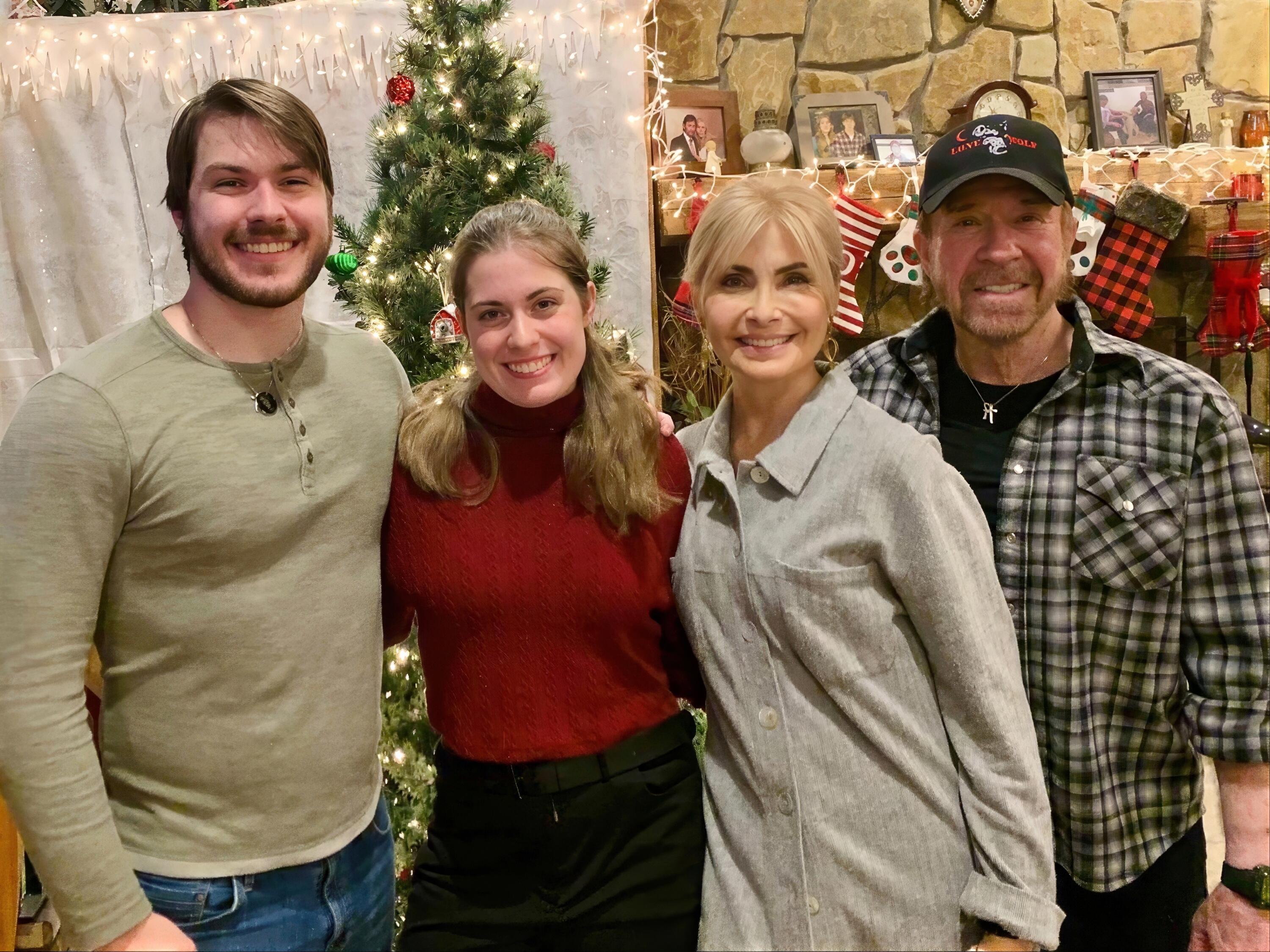 Chuck Norris with his wife Gena and their grown-up twins, Danilee and Dakota, posing for a Christmas family photo.