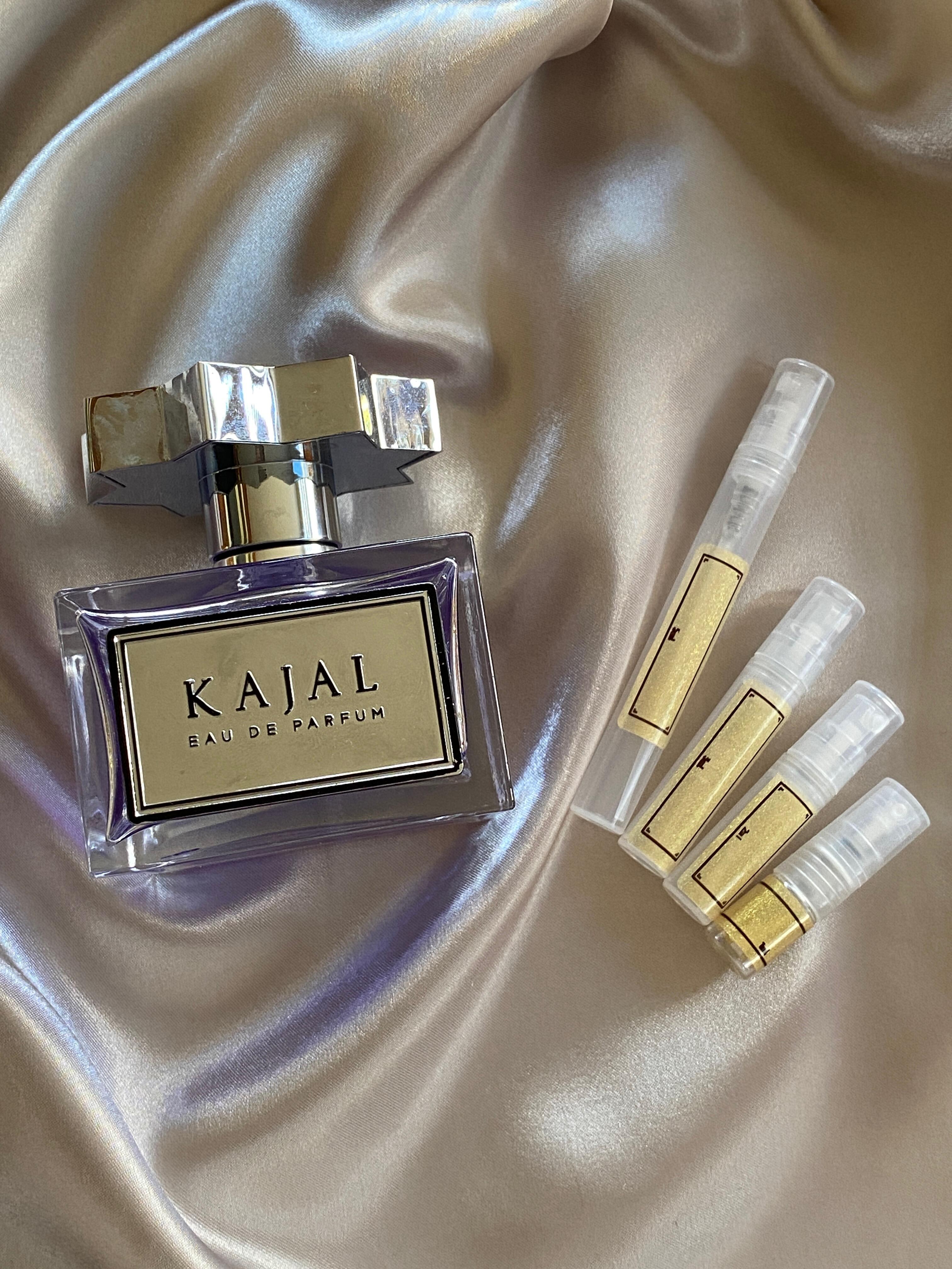 kajal EDP perfume bottle with samples laid on silk