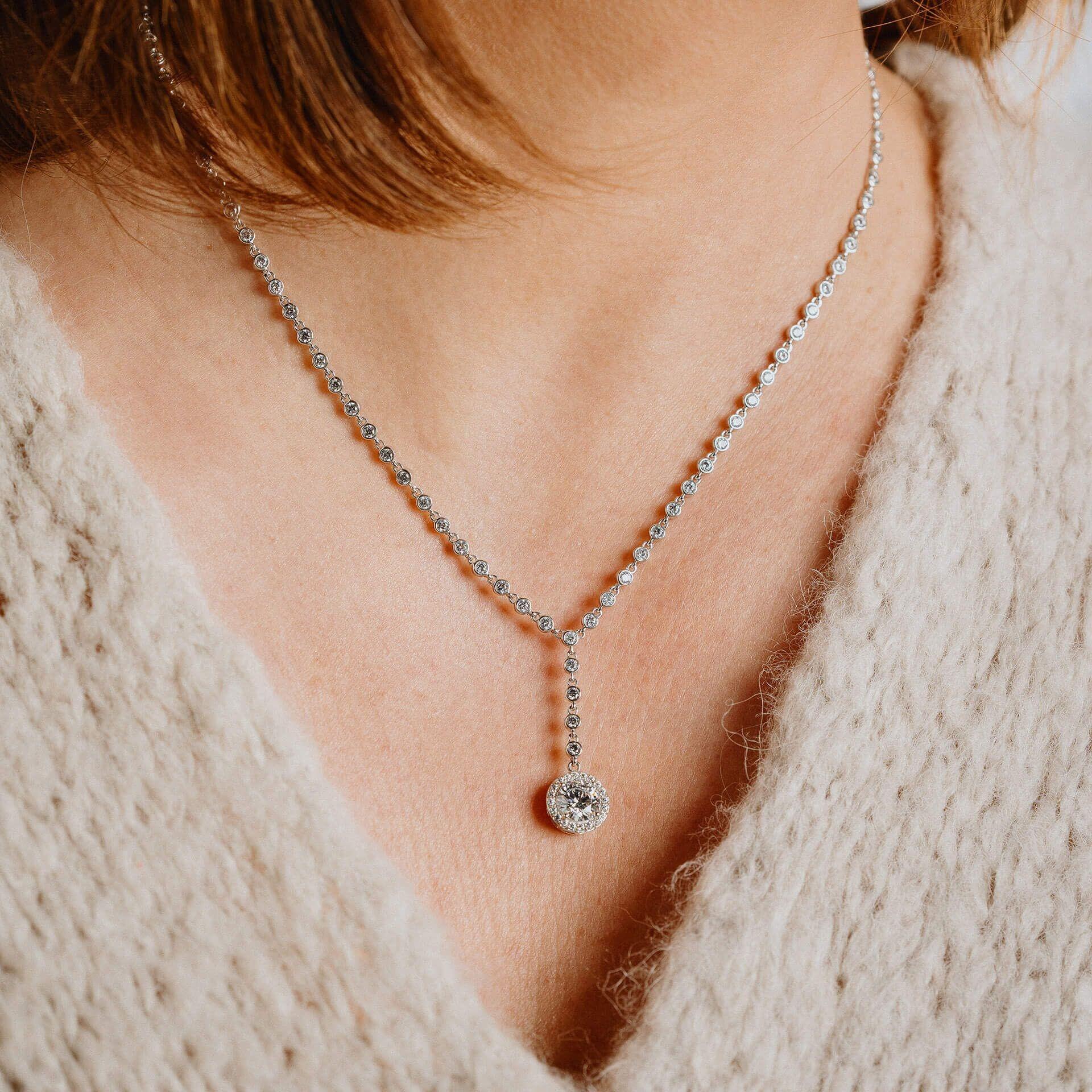"3.65ct pave set Diamonfire® drop necklace with 57-facet cubic zirconia stones on 43cm sterling silver, triple plated for durability and certified skin safe, presented in black Diamonfire® silk packaging with jewelry box, gift bag, and branded ribbon."