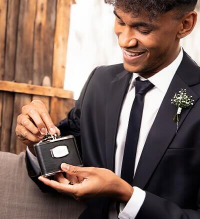 "fredbennett® Black Leather & Stainless Steel Hip Flask – a sleek and rugged gift for him with free engraving. Personalise with initials, dates, or a message for a meaningful keepsake. Available at Gold and Diamonds."