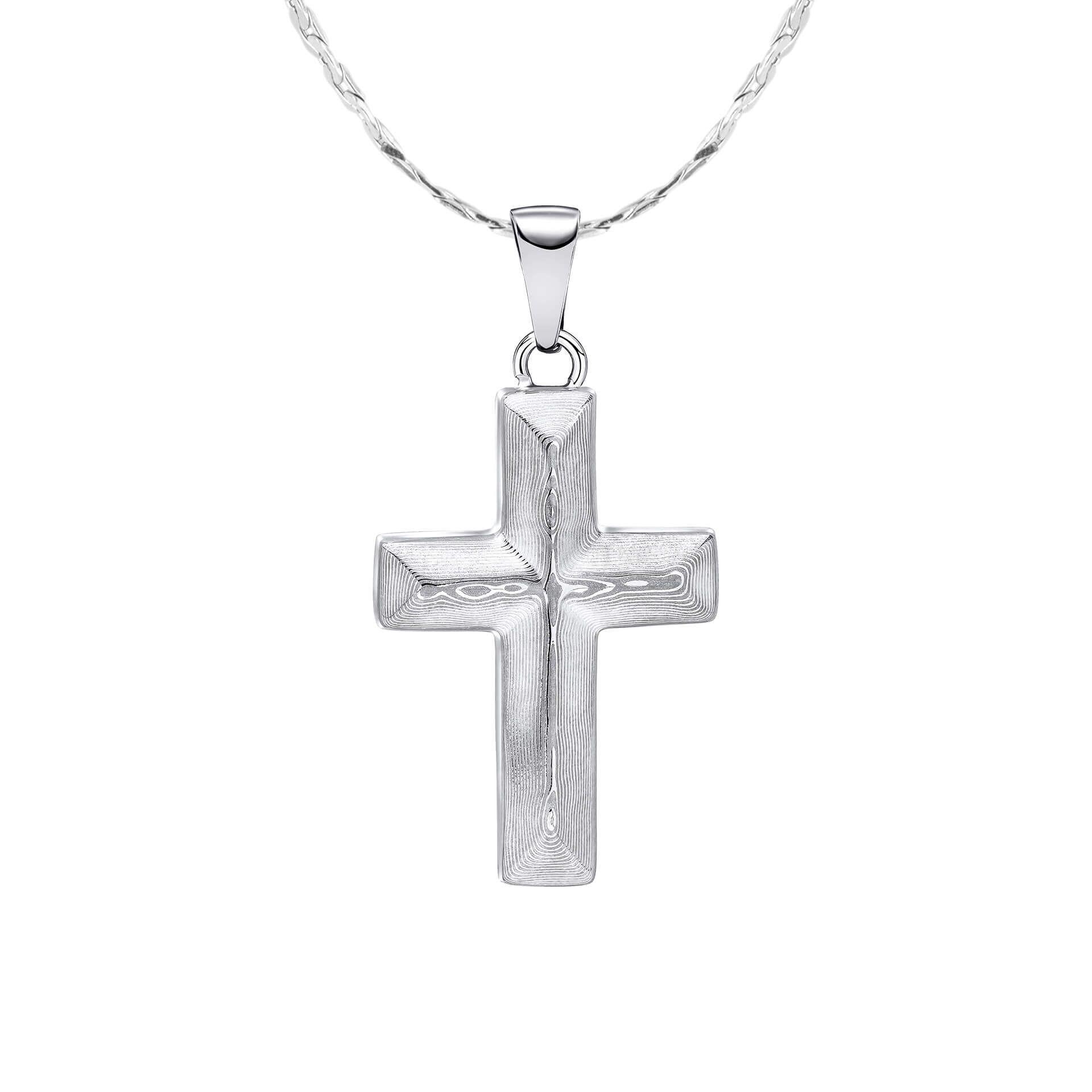 "fredbennett® Damascus Steel Cross Pendant with stainless steel chain – featuring rippling grain texture and bold structure. Hypoallergenic and presented in a suede pouch from Gold and Diamonds."