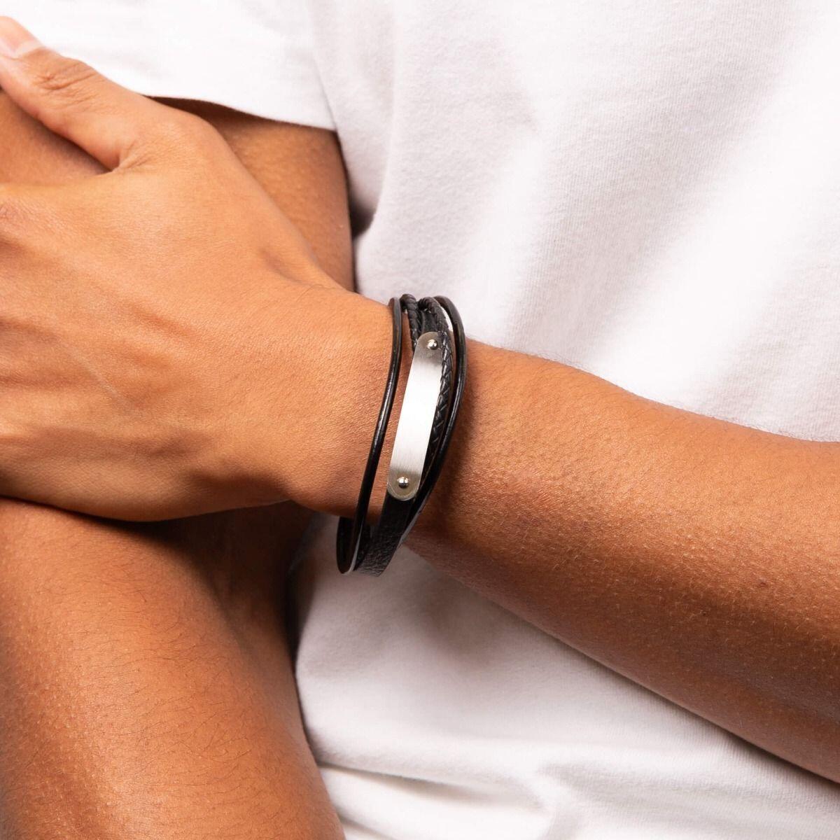 "fredbennett® Multi-Strand Woven Black Leather Bracelet – A stylish men’s bracelet crafted from soft black woven leather, featuring an engravable stainless steel ID bar and a secure magnetic clasp. Free custom engraving available. AnchorCert® certified and presented in luxury suede packaging from Gold and Diamonds."