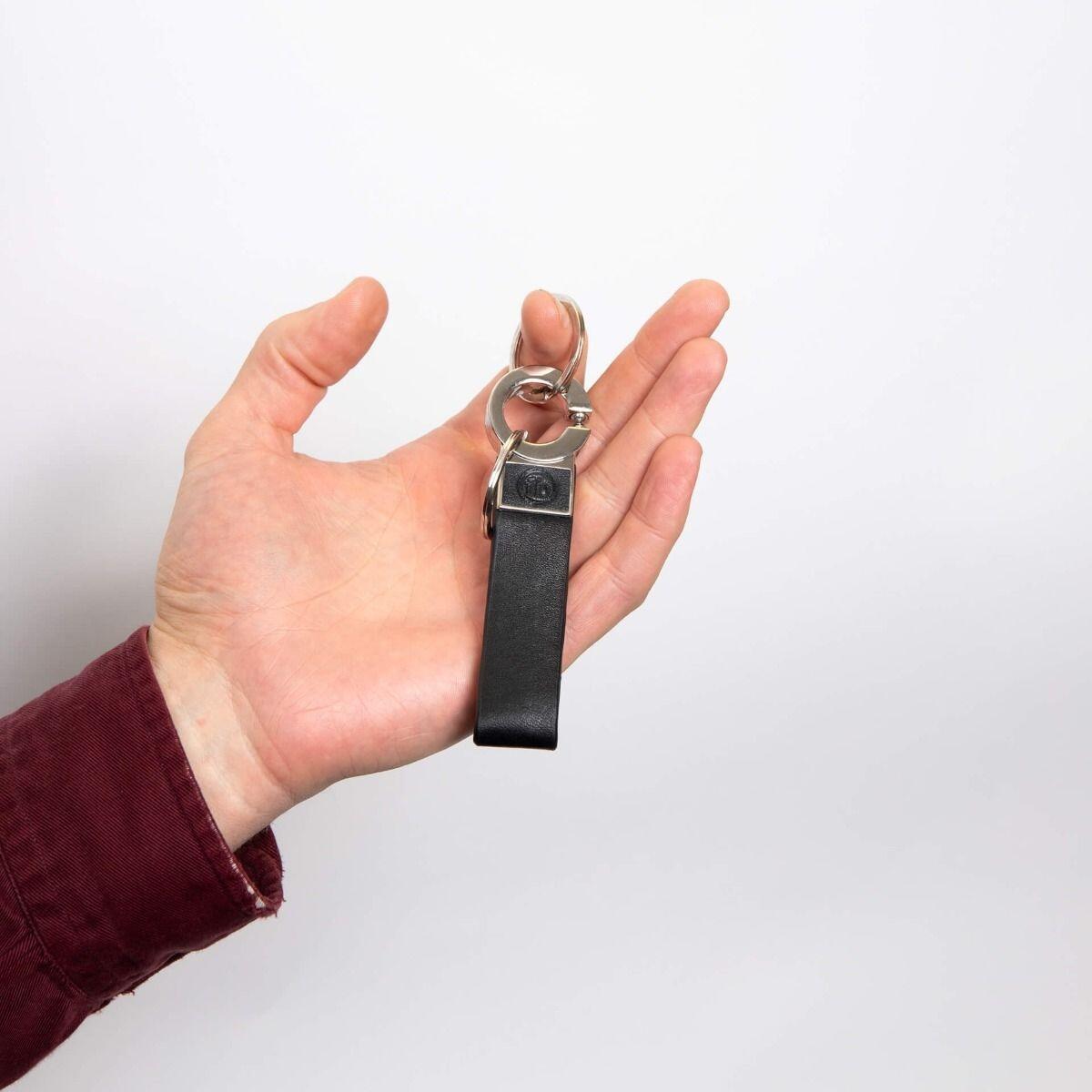 "fredbennett® Double Ring Black Leather Keychain – crafted from sleek leather with a dual ring design and free engraving on the strap or back metal plate. A perfect personal gift for him, available at Gold and Diamonds."