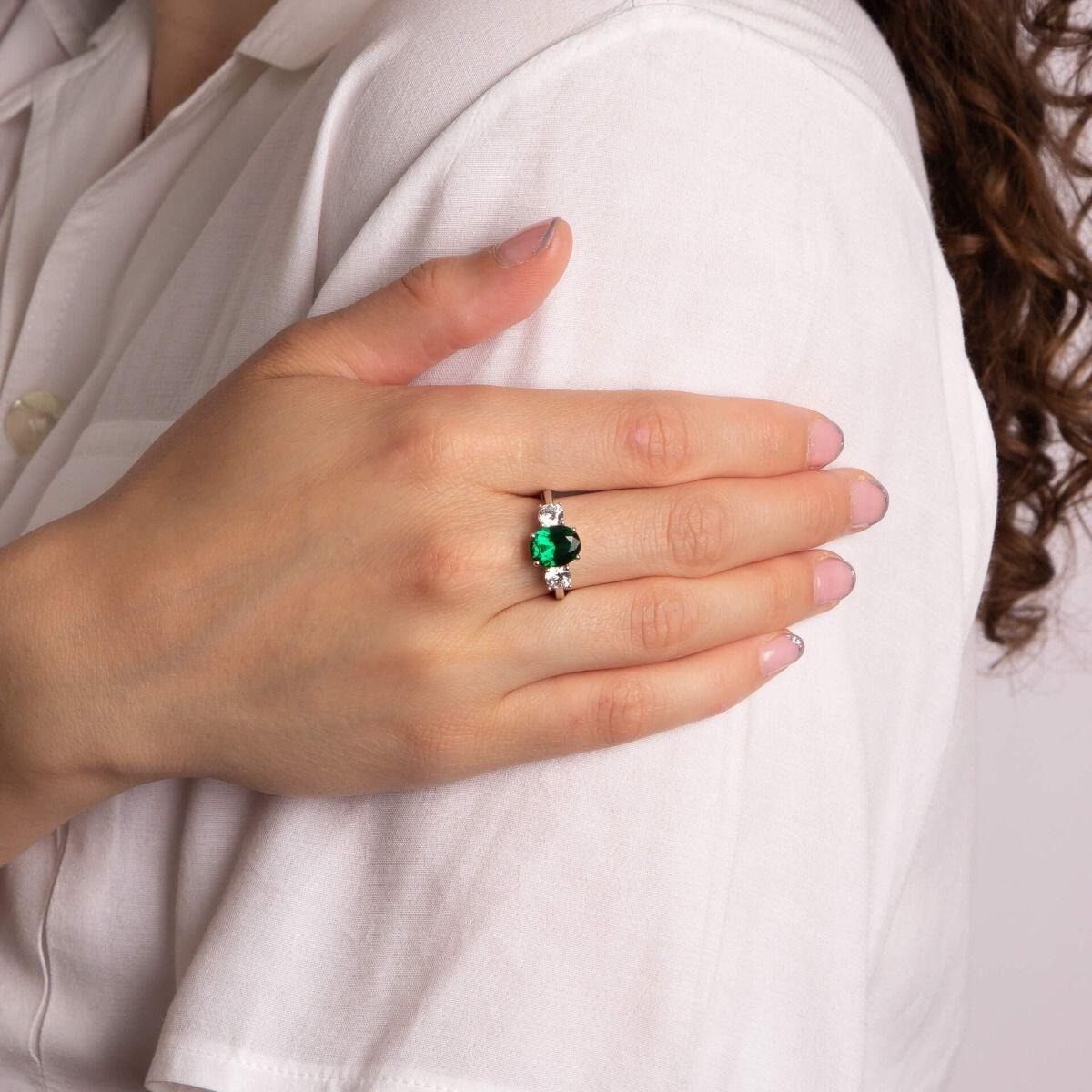 Diamonfire® 5.73ct Green Emerald Oval Zirconia Trilogy Ring featuring a deep green oval centre stone with two clear zirconia accents, crafted in triple-plated sterling silver, presented in exclusive silk packaging with a luxury gift box and bag.