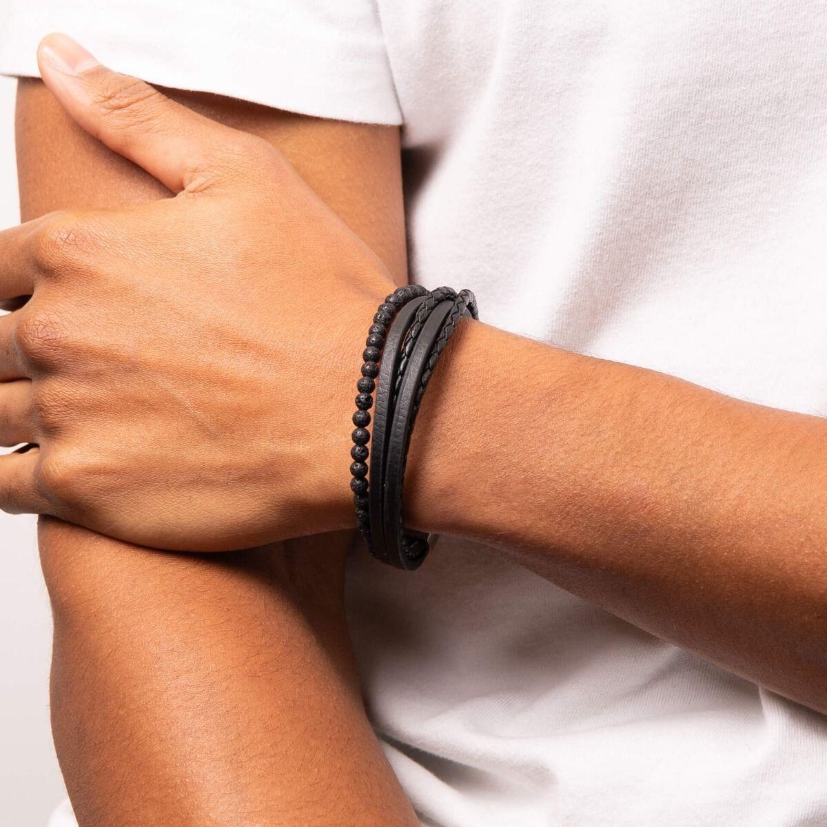 "fredbennett® Reborn Multi-Row Black Leather & Lava Bead Bracelet – A bold and sustainable men’s bracelet crafted from recycled black leather and natural lava beads, secured with a stainless steel magnetic clasp. Available in different lengths for the perfect fit. AnchorCert® certified and presented in luxury suede packaging from Gold and Diamonds."
