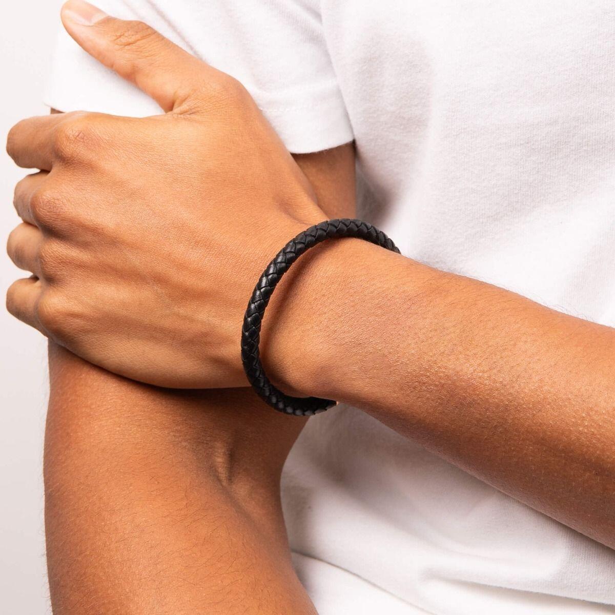 "fredbennett® Plaited Black Leather Bracelet – A stylish men’s bracelet crafted from genuine black plaited leather, featuring a rose gold IP stainless steel magnetic clasp. Perfect for everyday wear and stacking. AnchorCert® certified and presented in luxury suede packaging from Gold and Diamonds."