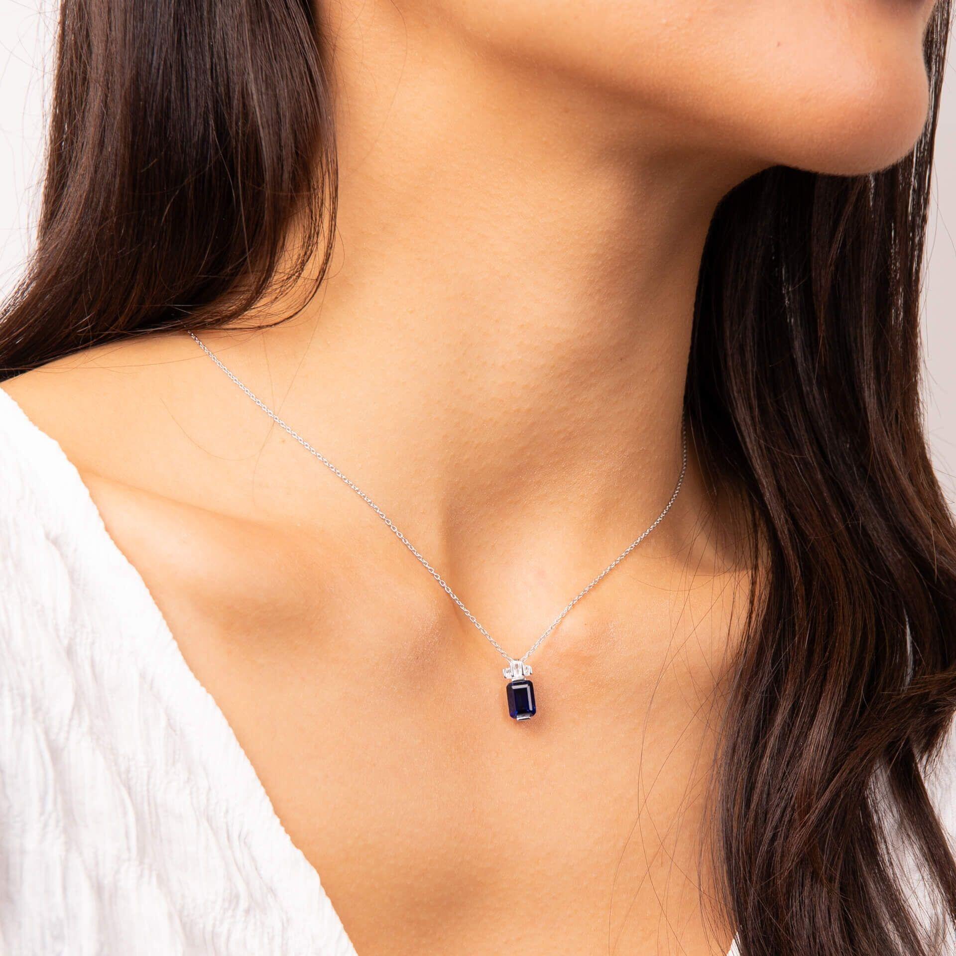 "Diamonfire® Sapphire Blue Emerald Cut Zirconia Pendant – deep blue centre with clear halo in triple plated sterling silver. Presented in luxury silk packaging from Gold and Diamonds."