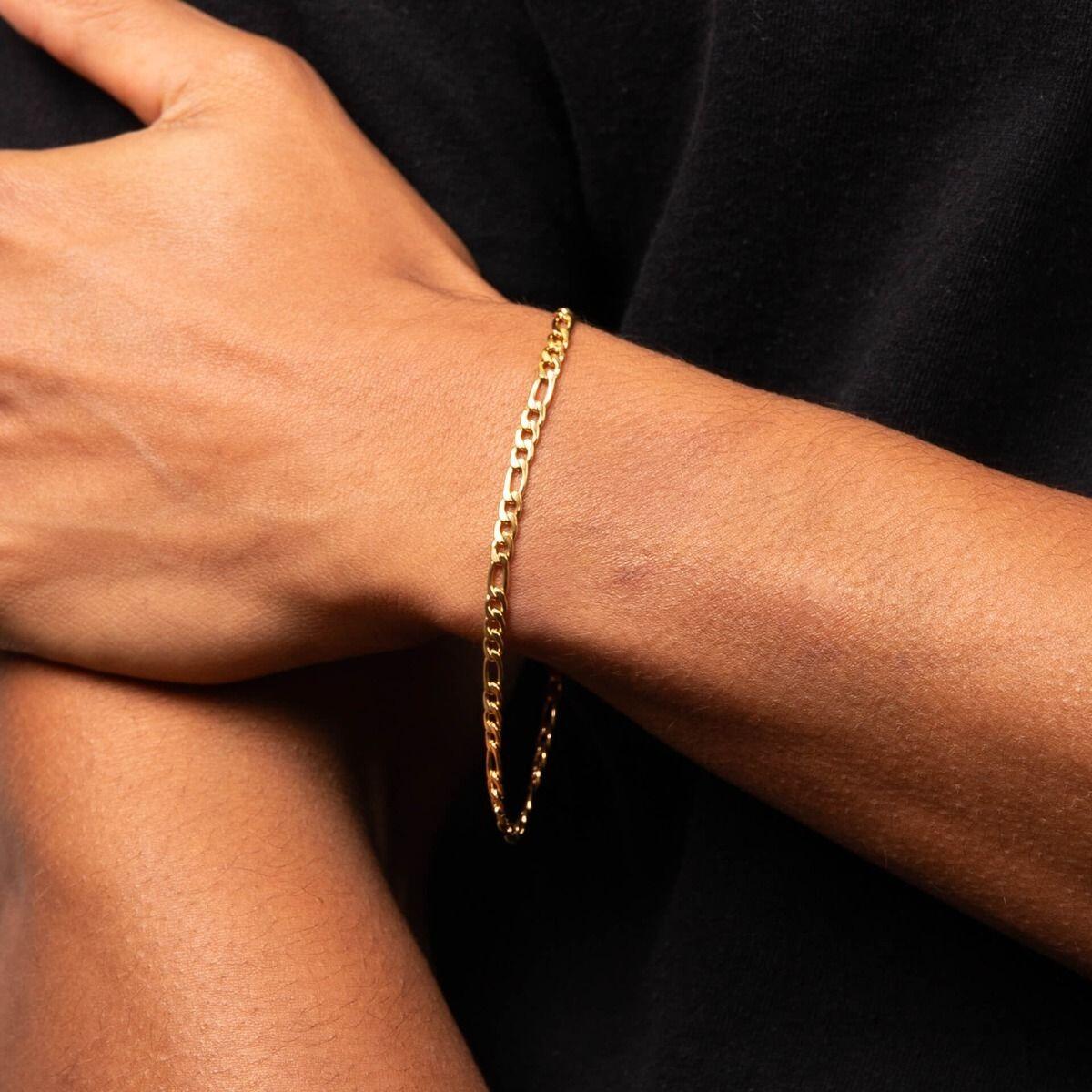 "fredbennett® Figaro Link Chain Bracelet – A stylish and timeless men’s bracelet crafted from stainless steel with yellow gold IP plating, designed for everyday elegance. Perfect for all occasions and pairs beautifully with the matching Figaro link chain necklace. AnchorCert® certified and presented in luxury suede packaging from Gold and Diamonds."