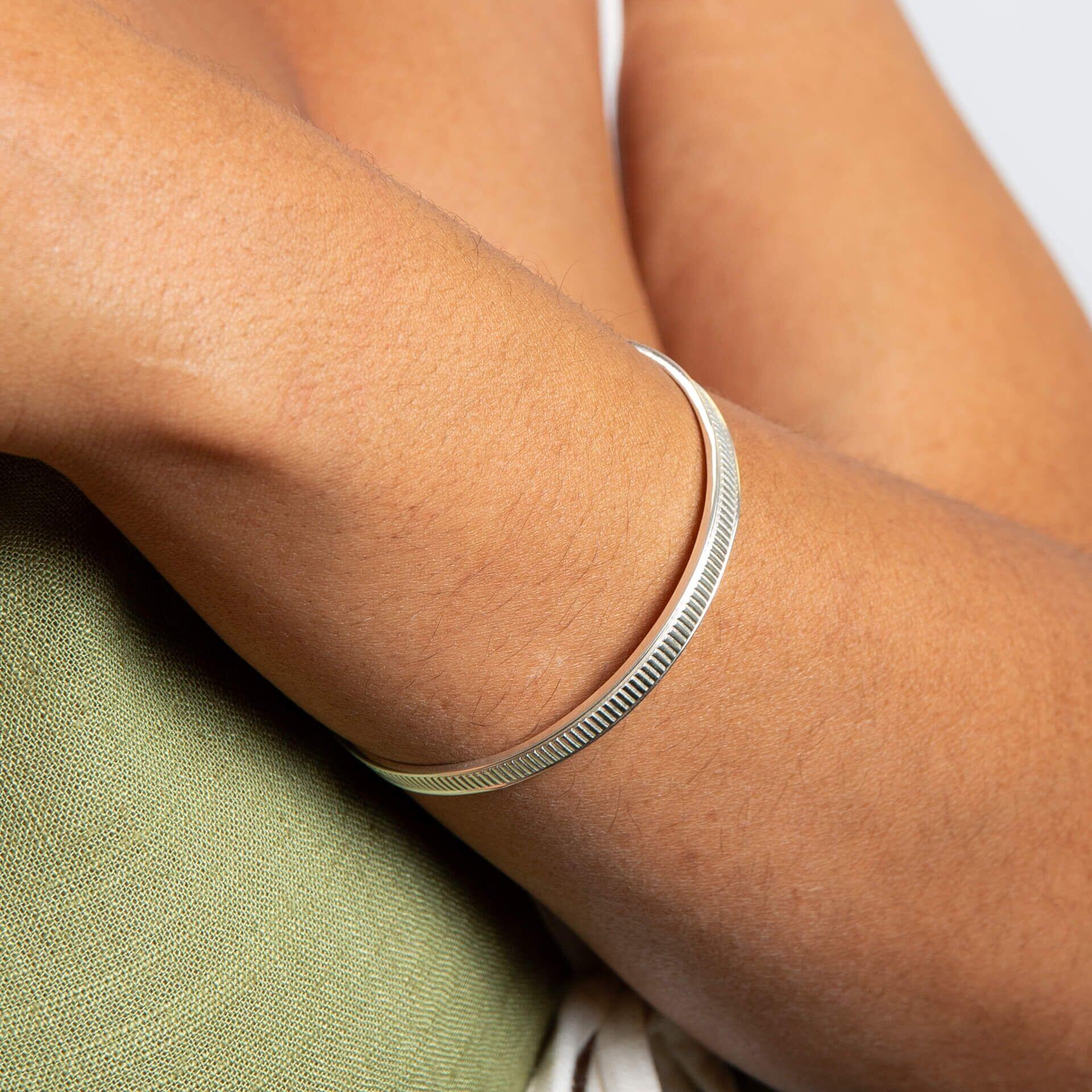 "Recycled sterling silver ridged spinner bangle with calming tactile texture, personalised with engraving and handwritten message from Gold and Diamonds"