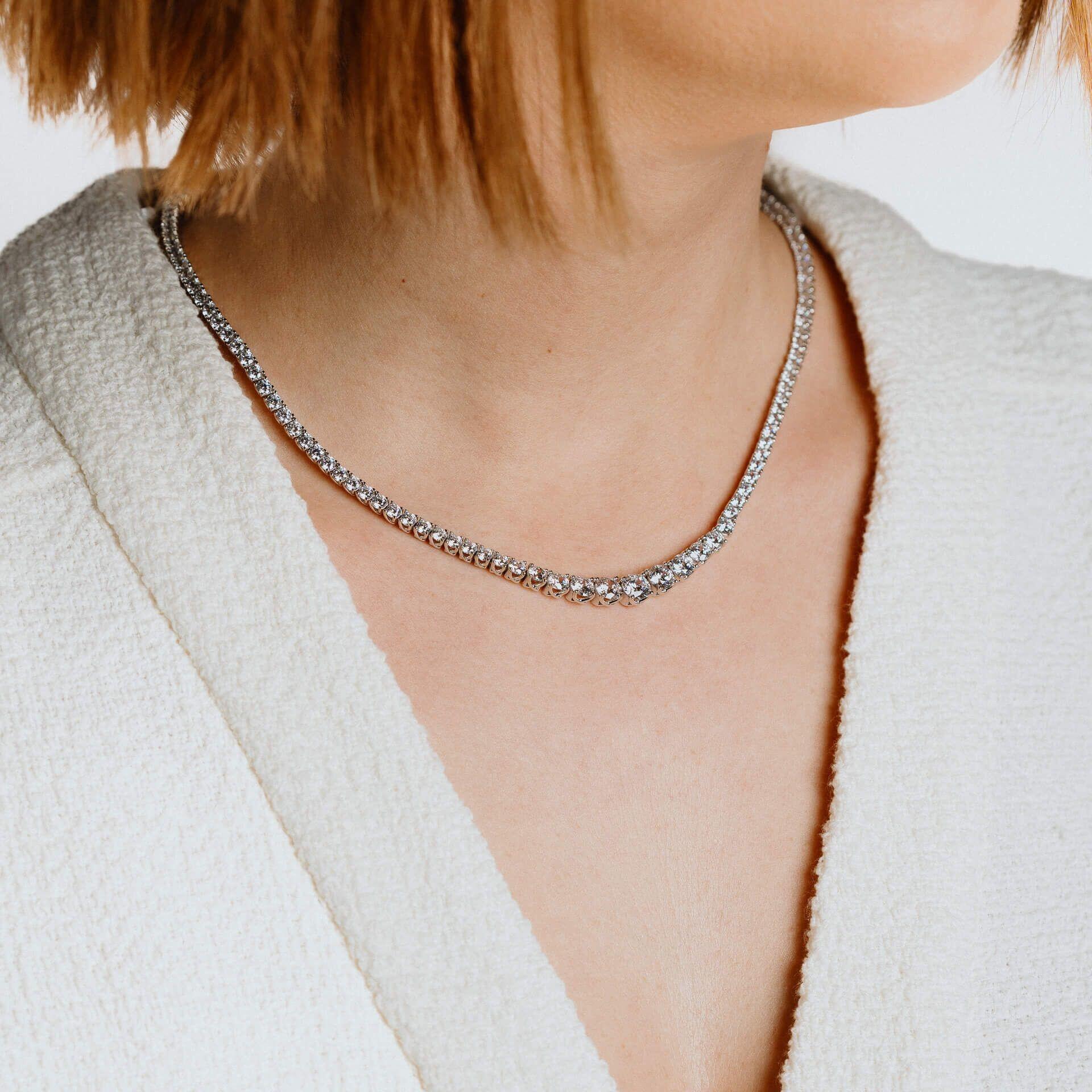 "16.2ct Graduated Zirconia Tennis Necklace featuring Diamonfire® cubic zirconia stones cut with 57 facets, set in triple plated sterling silver, AnchorCert Pro certified skin safe, in exclusive silk packaging with gift bag."