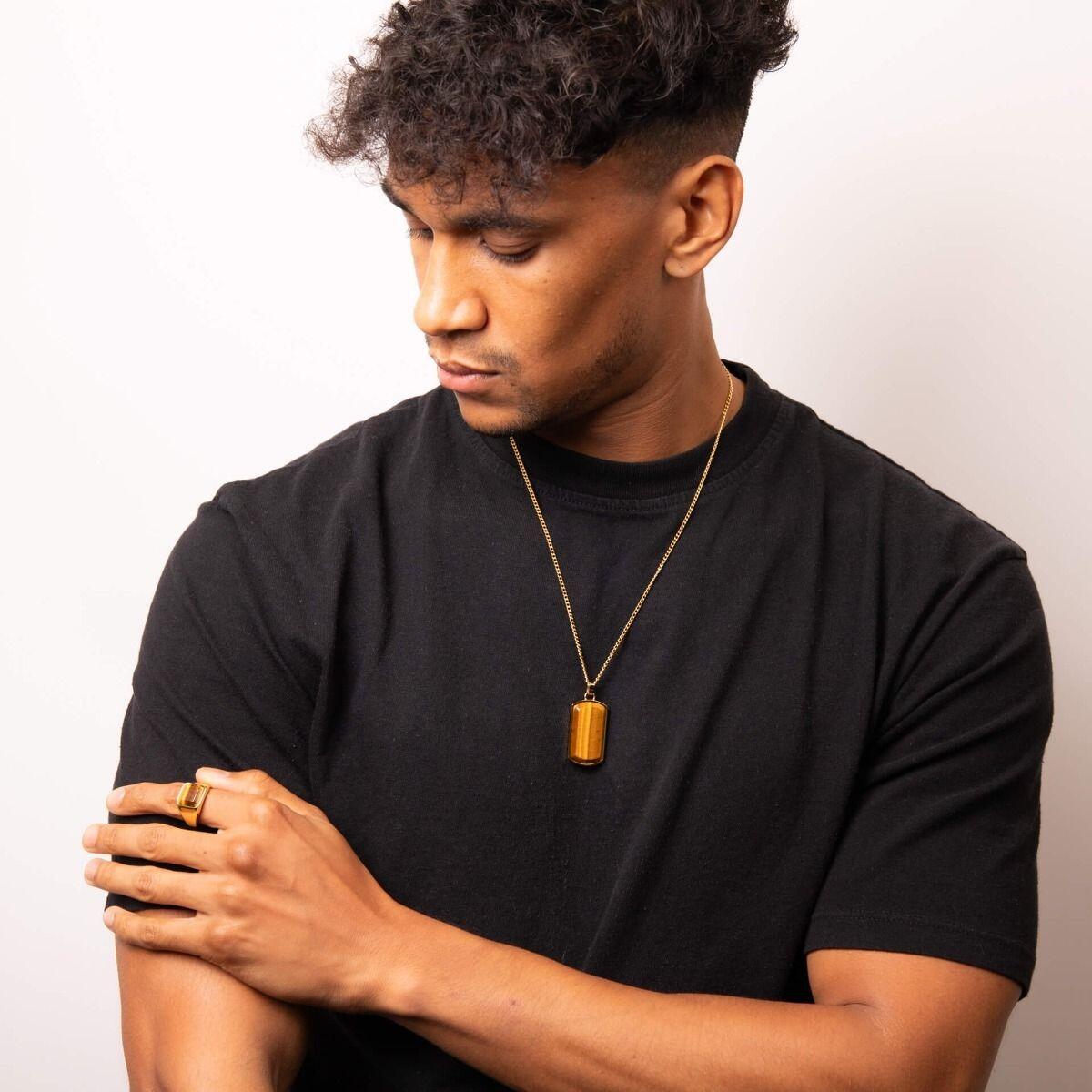 "Stainless Steel Signet Ring with yellow gold IP finish and natural yellow tiger eye, AnchorCert Pro certified skin safe, by fredbennett®, paired with matching dog tag necklace."