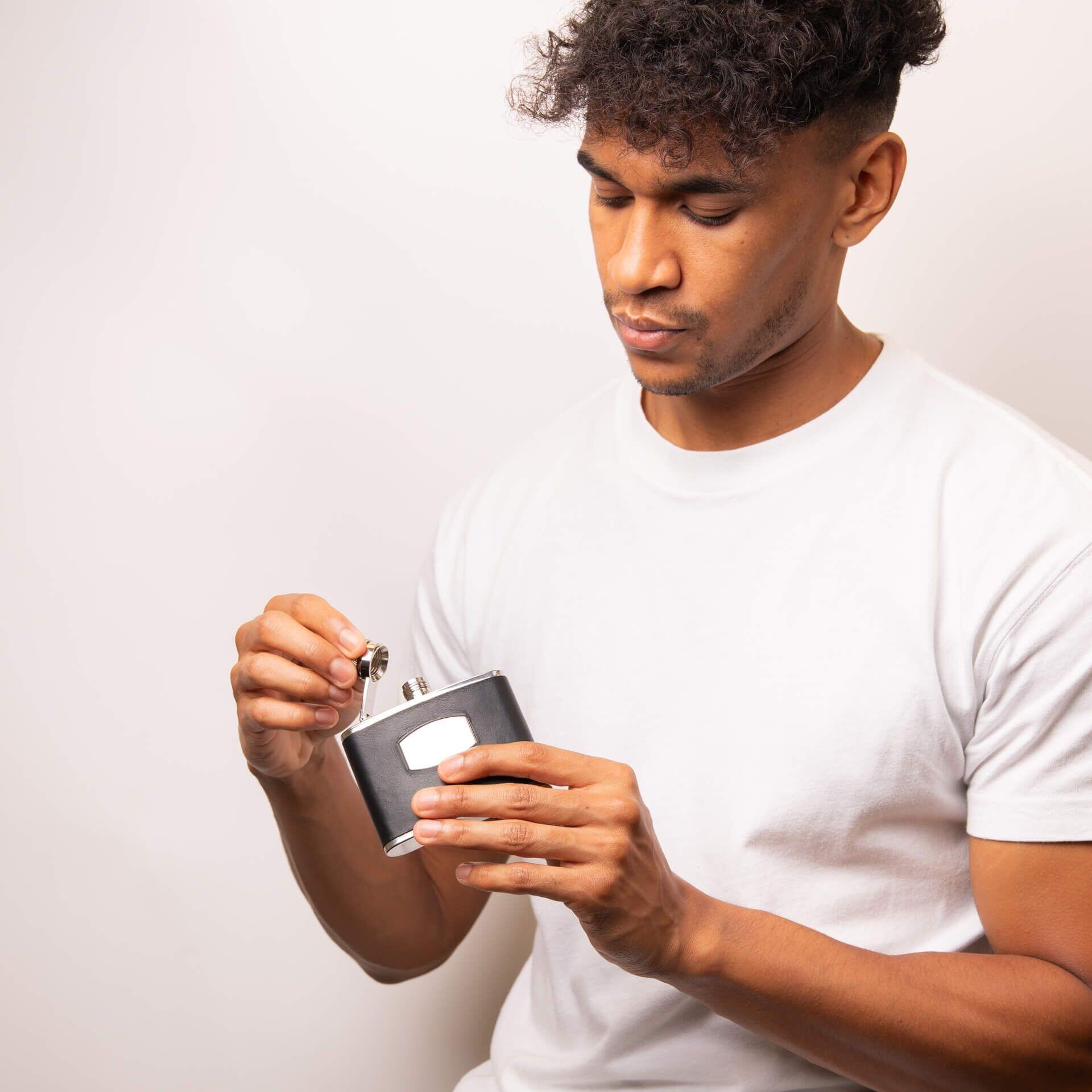 "fredbennett® Black Leather & Stainless Steel Hip Flask – a sleek and rugged gift for him with free engraving. Personalise with initials, dates, or a message for a meaningful keepsake. Available at Gold and Diamonds."