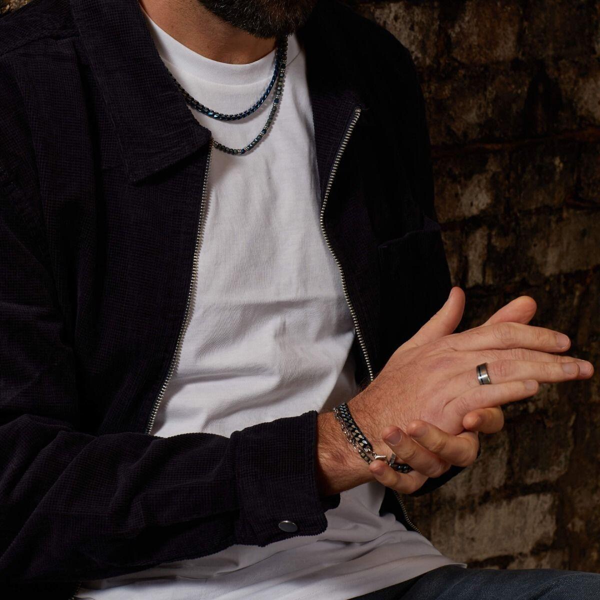 "fredbennett® Blue Hematite Bead Necklace – features natural blue and green hematite beads with stainless steel accents, inspired by nature’s calm and depth. Skin-safe and presented in a suede pouch from Gold and Diamonds."