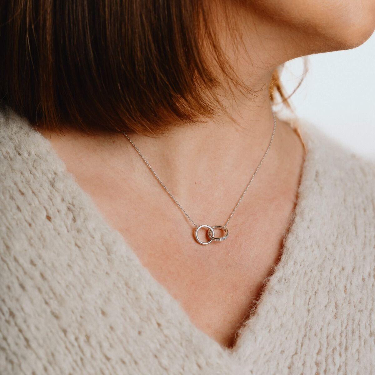 "0.61ct interlocking rings necklace featuring 57-facet Diamonfire® cubic zirconia stones set in triple plated sterling silver, presented in exclusive silk packaging with a gift bag."