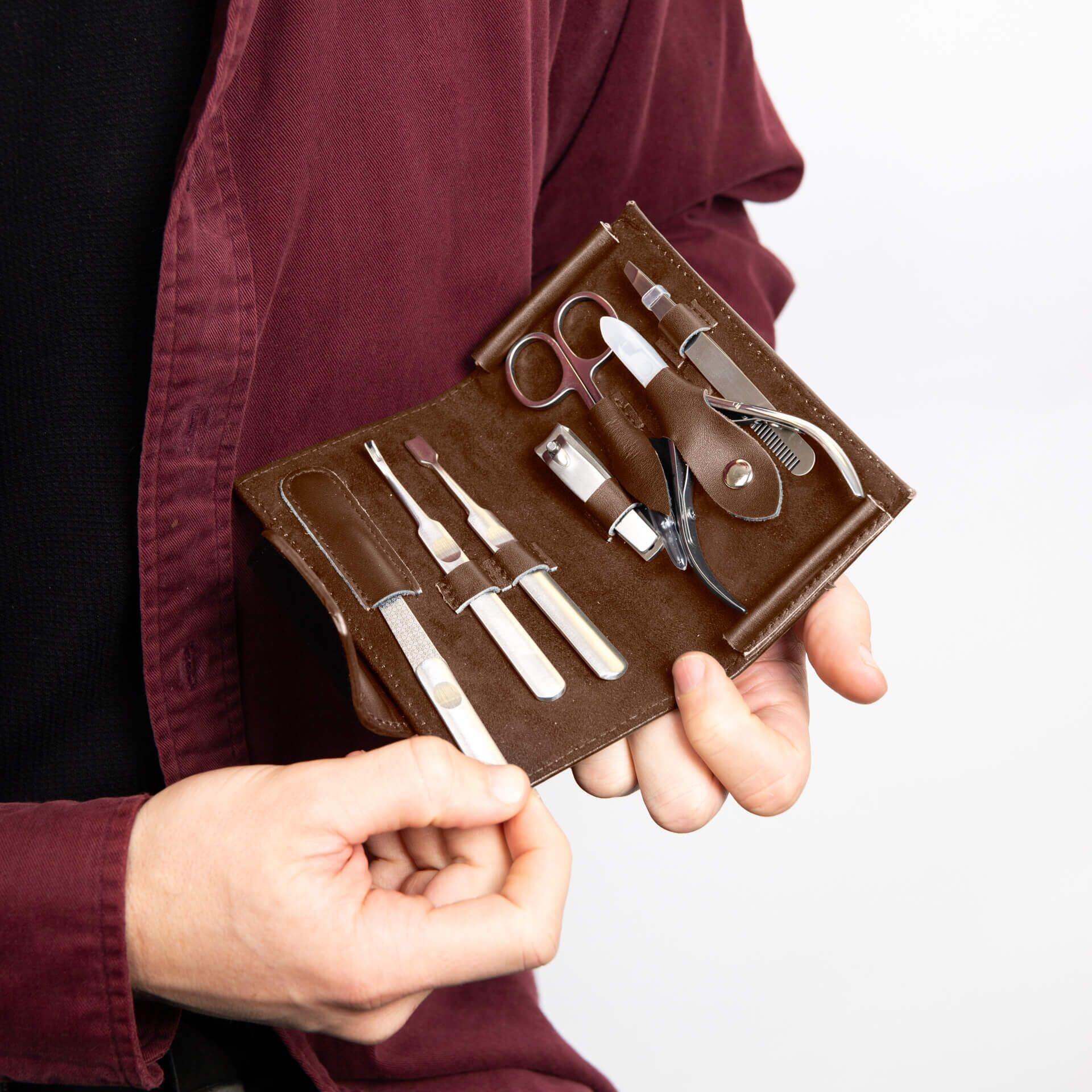 "fredbennett® Brown Leather and Stainless Steel Travel Manicure Set – a compact, durable grooming kit in an engravable leather case. Includes scissors, clippers, and tweezers. Ideal gift for travellers, dads, and groomsmen. Available at Gold and Diamonds."