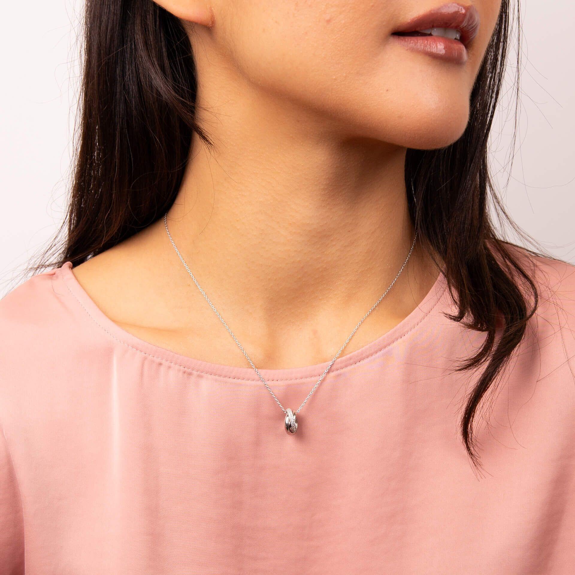 "Diamonfire® Triple Twist Pendant in sterling silver with 57-facet zirconia stones, triple plated in rhodium, palladium and platinum, AnchorCert Pro certified skin safe, presented in luxury silk packaging."