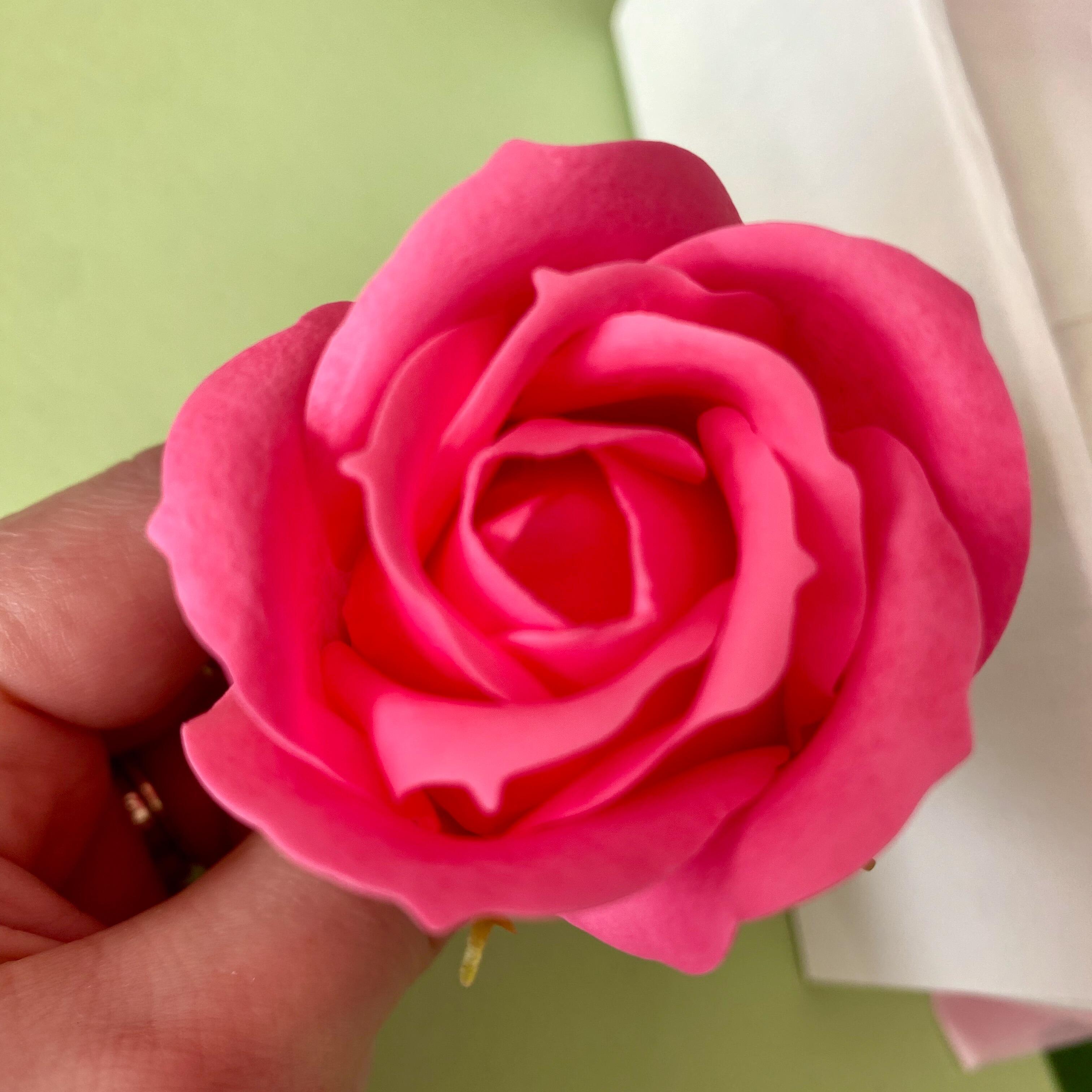 Close-up of rose soap flowers in pink gift packaging
