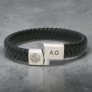 Close-up of St Christopher Safe Travels leather bracelet showing engraved silver charm detail