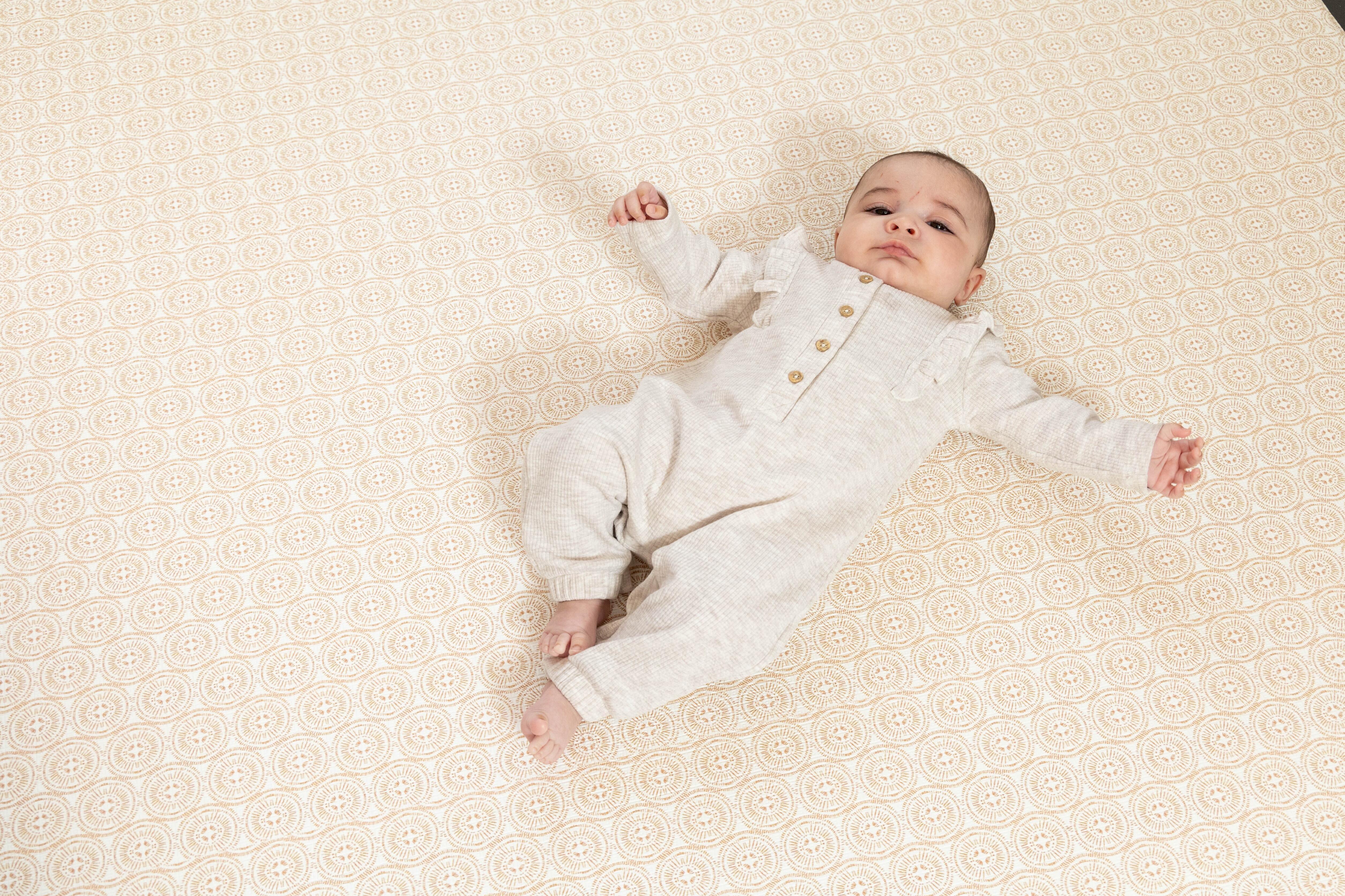 Warm-toned Large The Beginner Playmat in Soft Brass on living room flooring