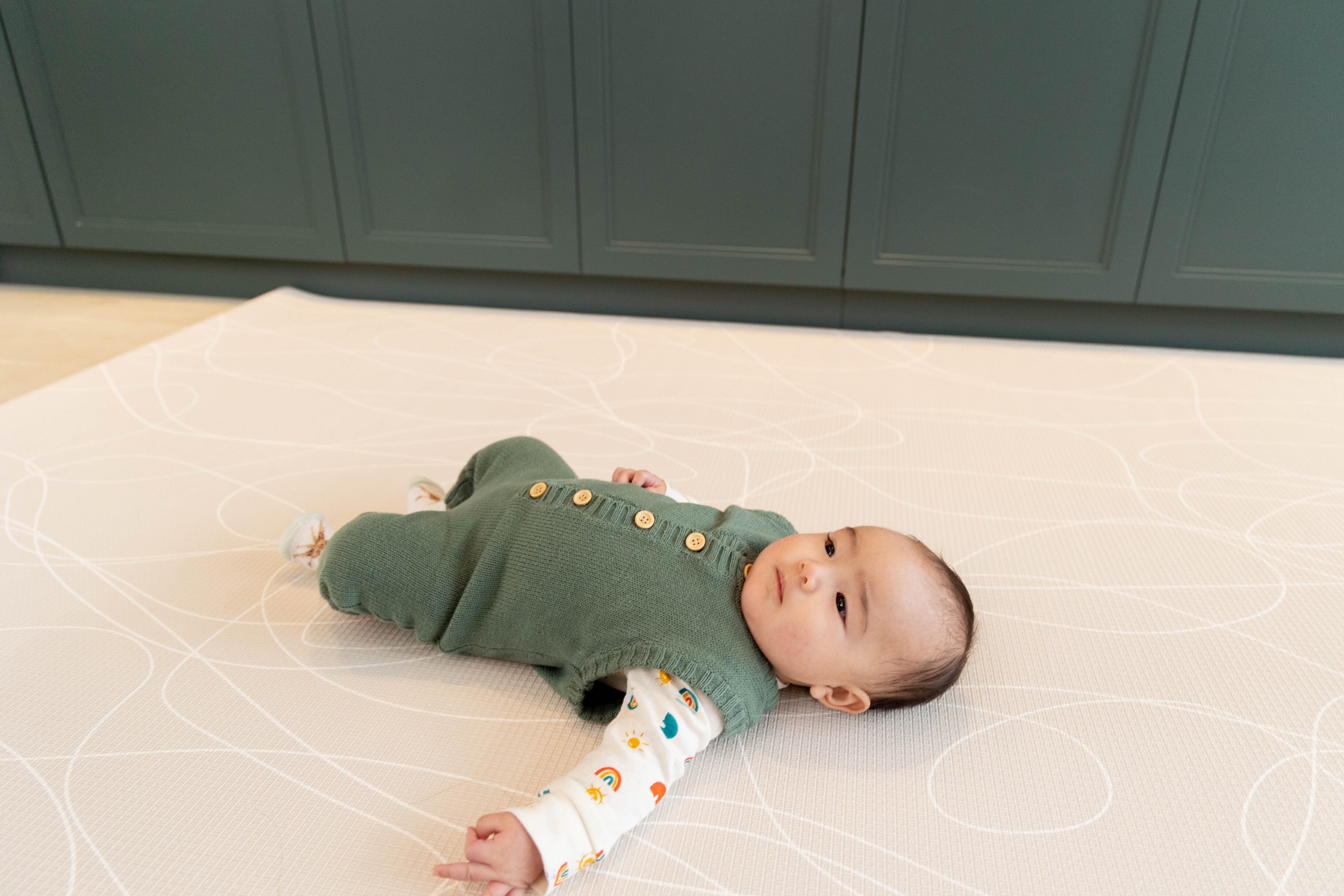 Adventure-inspired reversible Tiny Trekker Playmat on wooden flooring