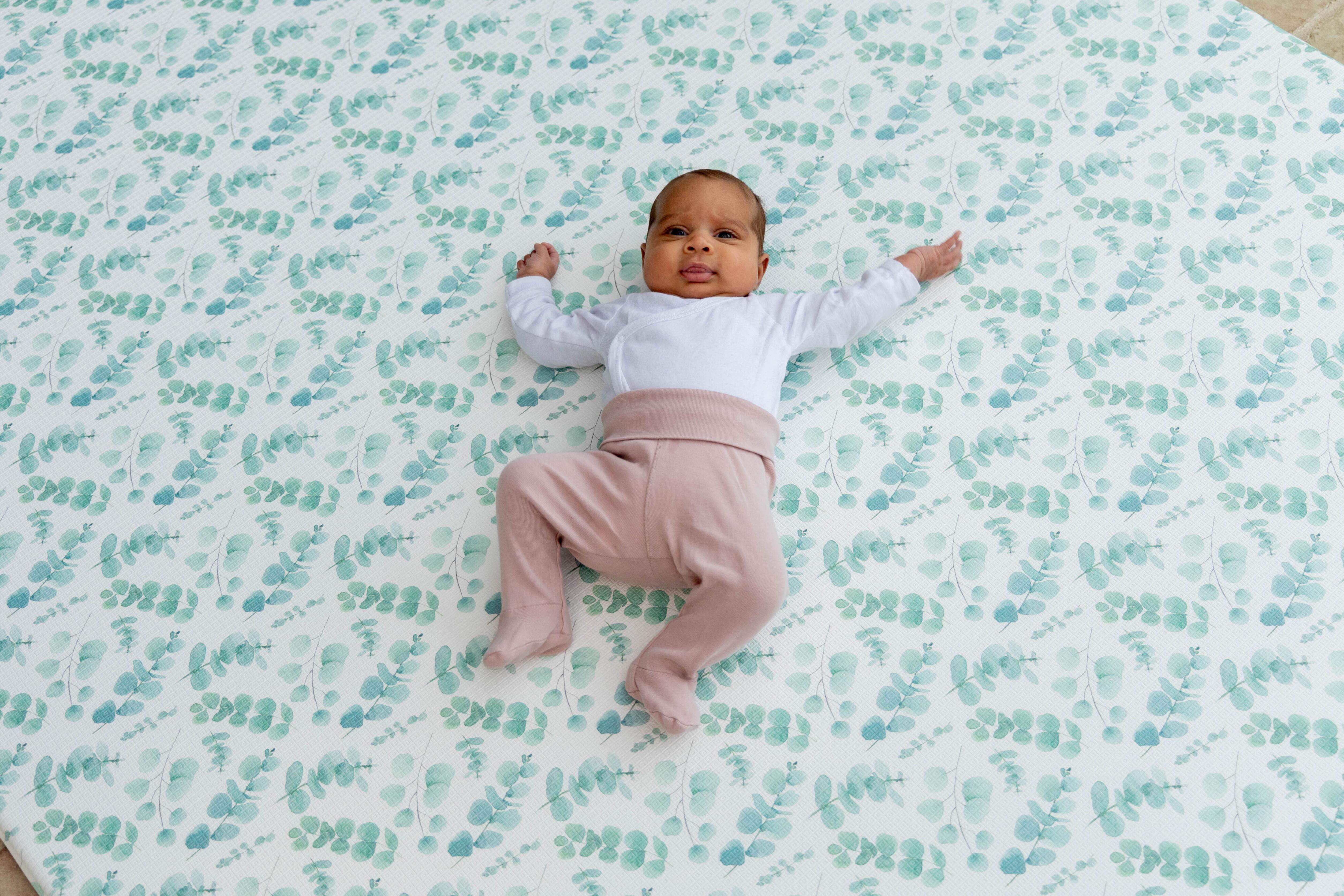 Baby playing on Botanical Green Fresh Eucalyptus Playmat – luxury reversible foam baby mat by Little Fae