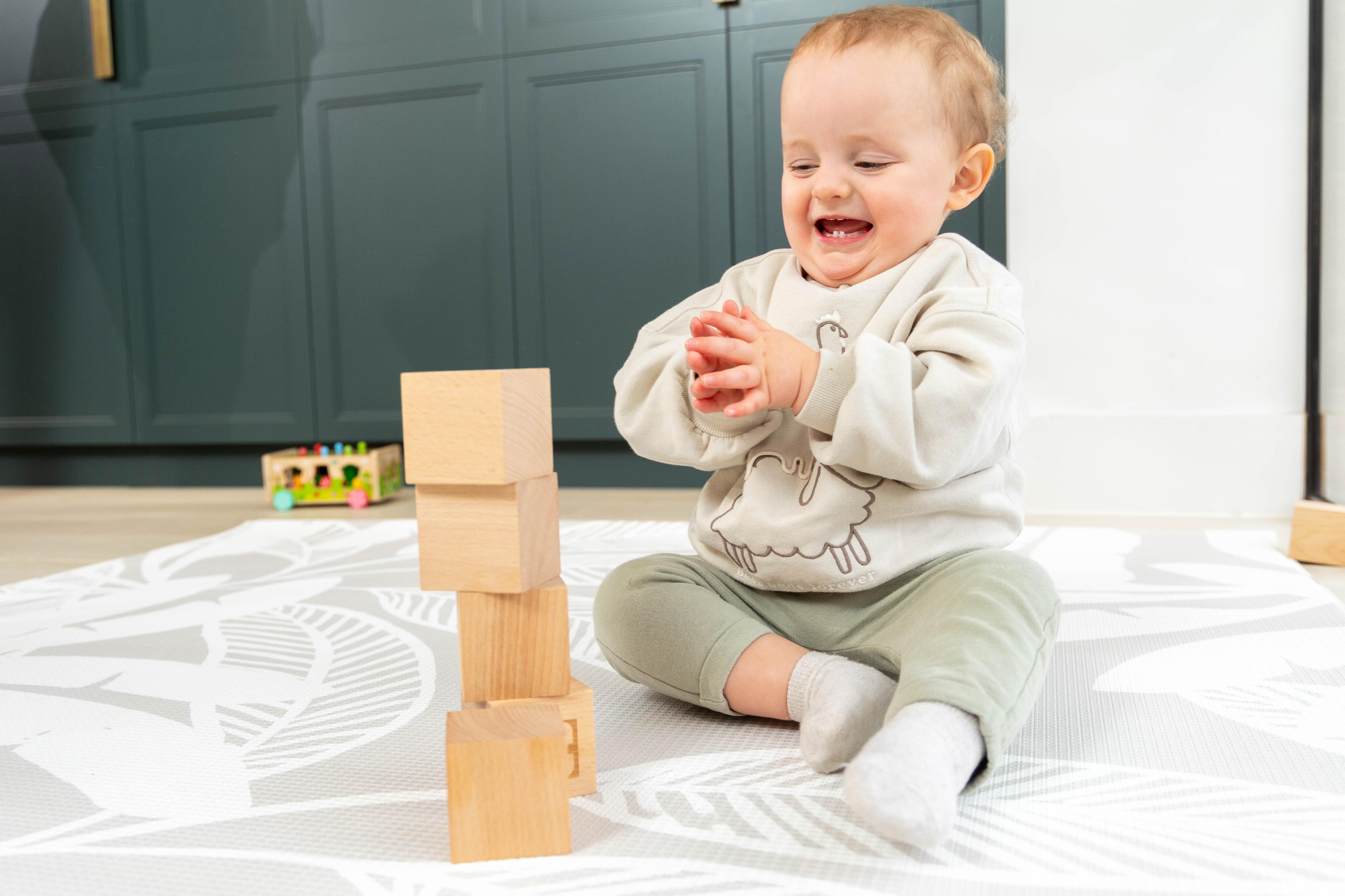 Lifestyle image of Scandi Bare Palms baby playmat – neutral reversible design complementing contemporary interiors