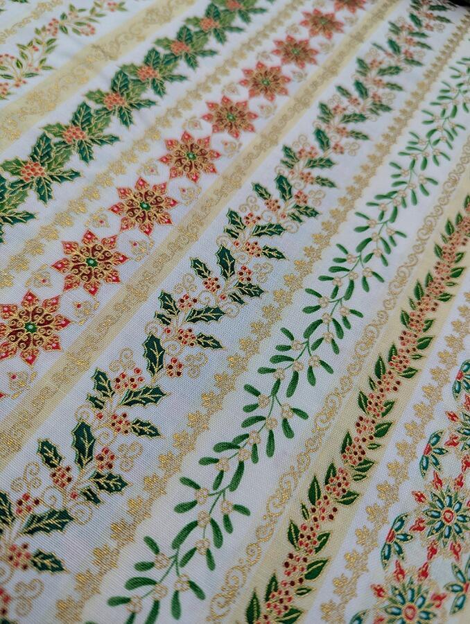 Makower Adorn, a traditional style Christmas fabric featuring gold metallic highlights.