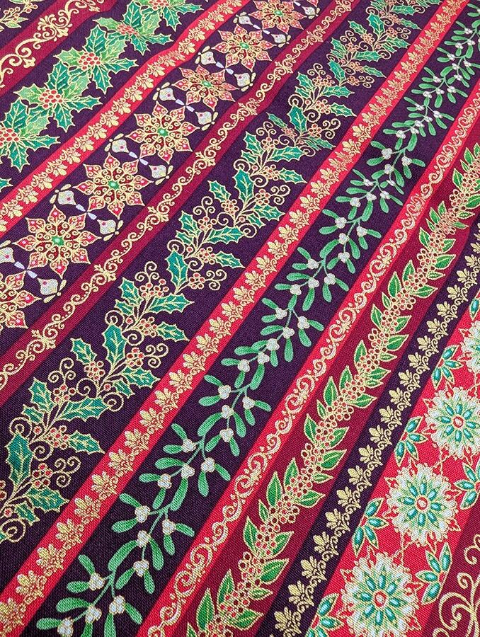 Makower Adorn, a traditional style Christmas fabric featuring gold metallic highlights.