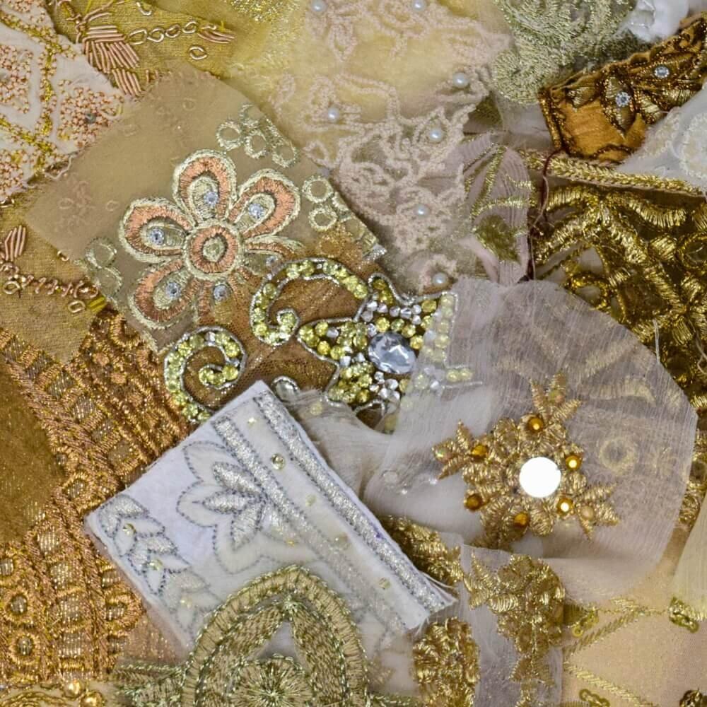 Close up detail of some embellished sari fabric scraps in a neutral colour mix