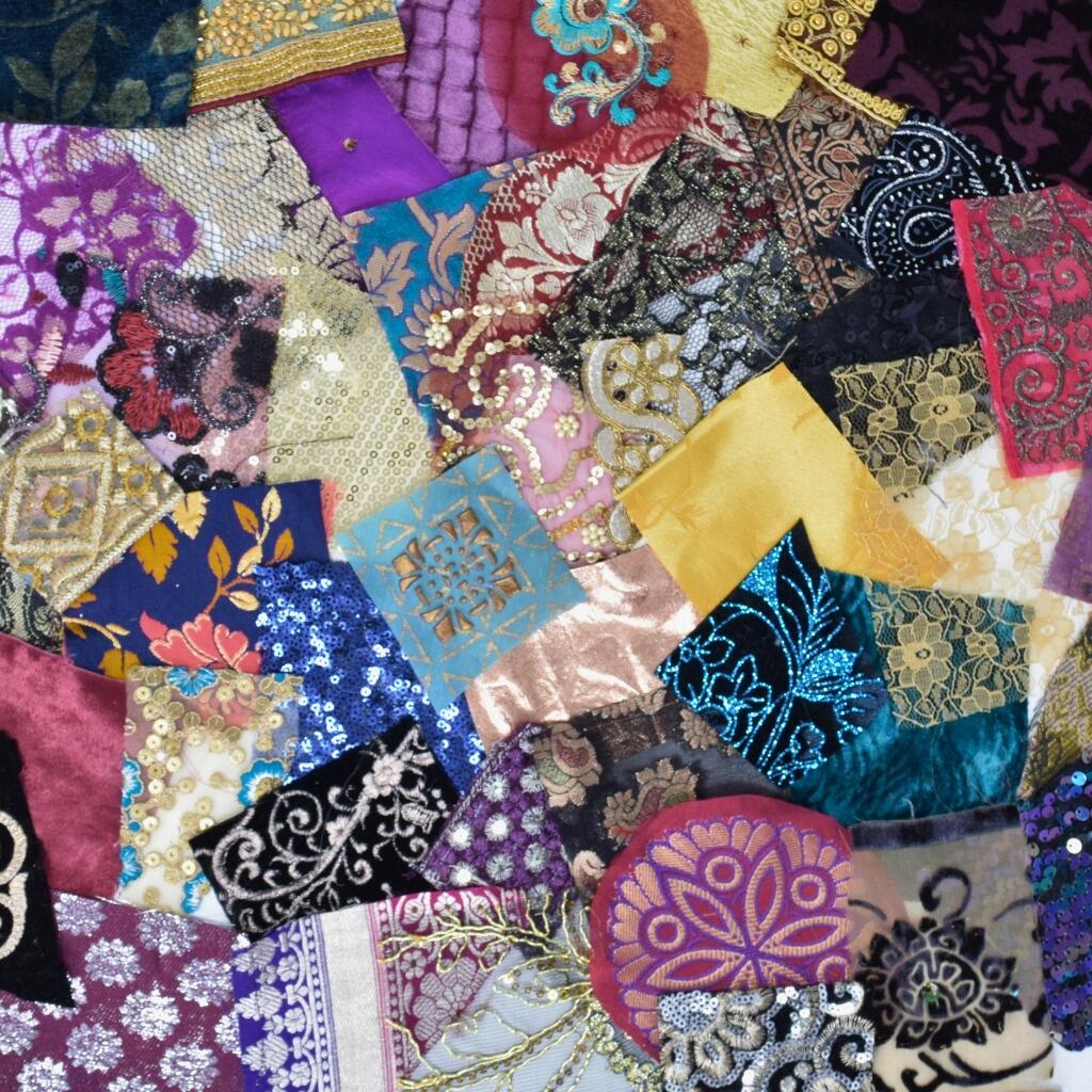Flat lay of a selection of opulent craft fabric pieces laid out in an overlapping patchwork style pattern